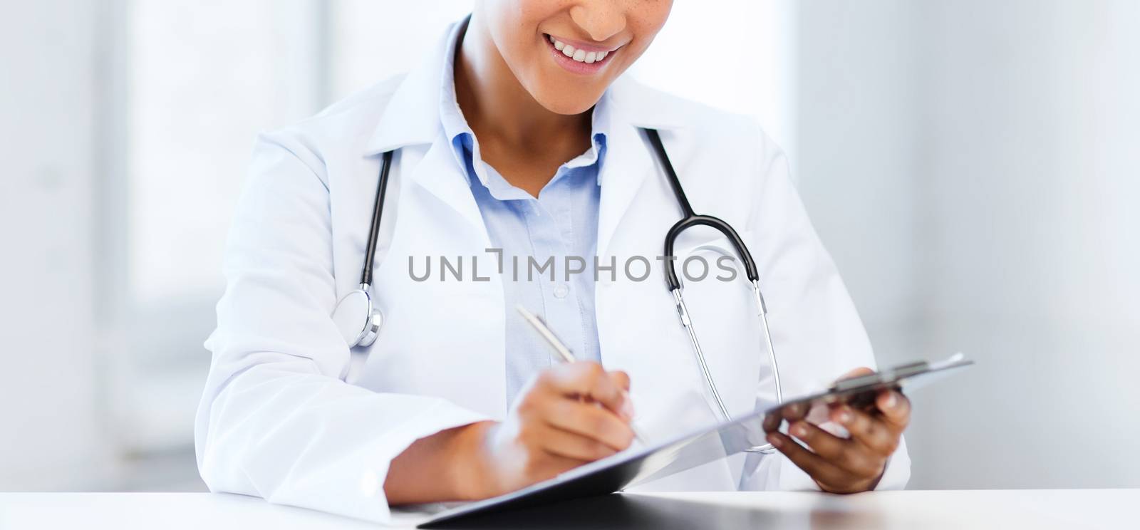female doctor writing prescription by dolgachov