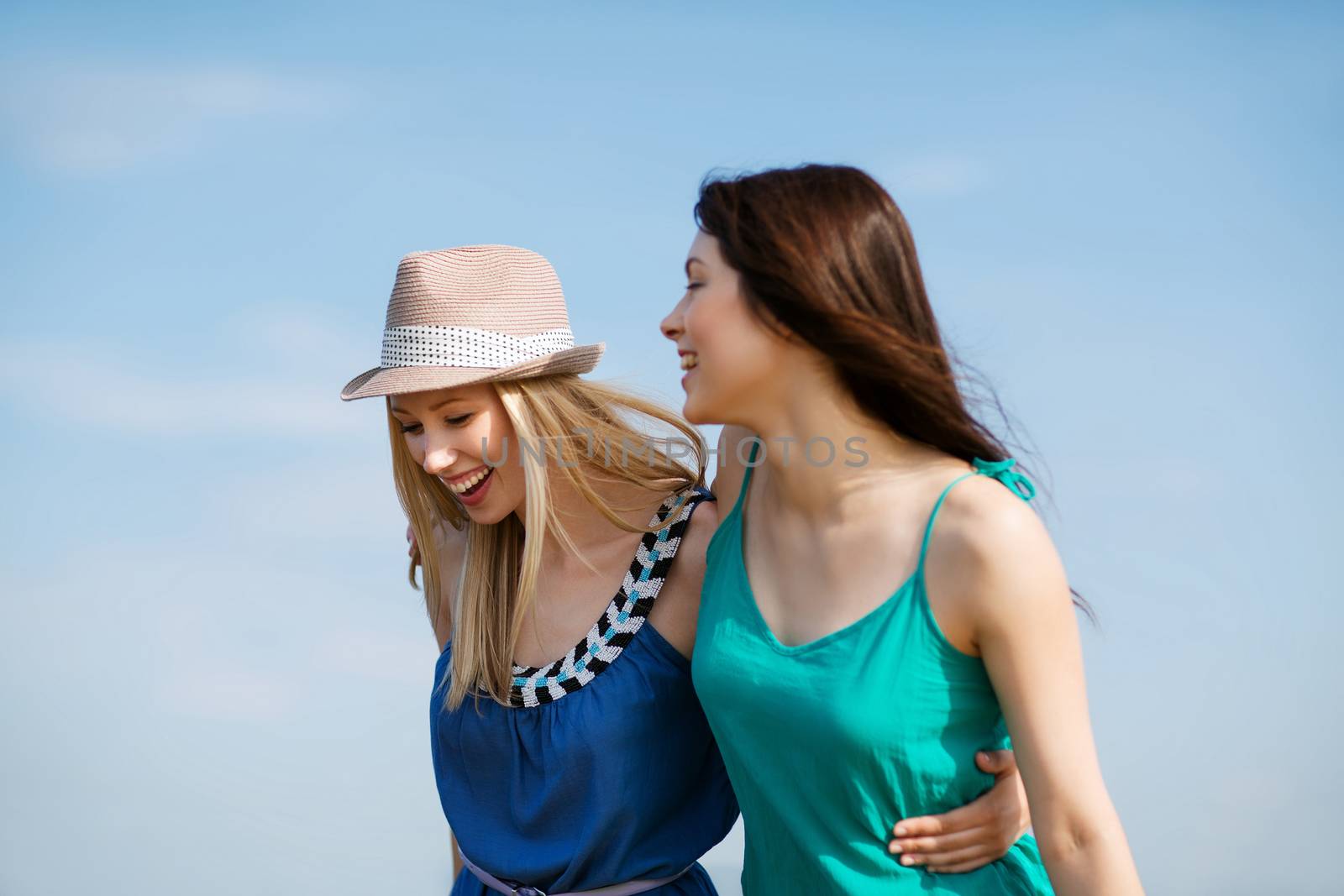 girls walking on the beach by dolgachov