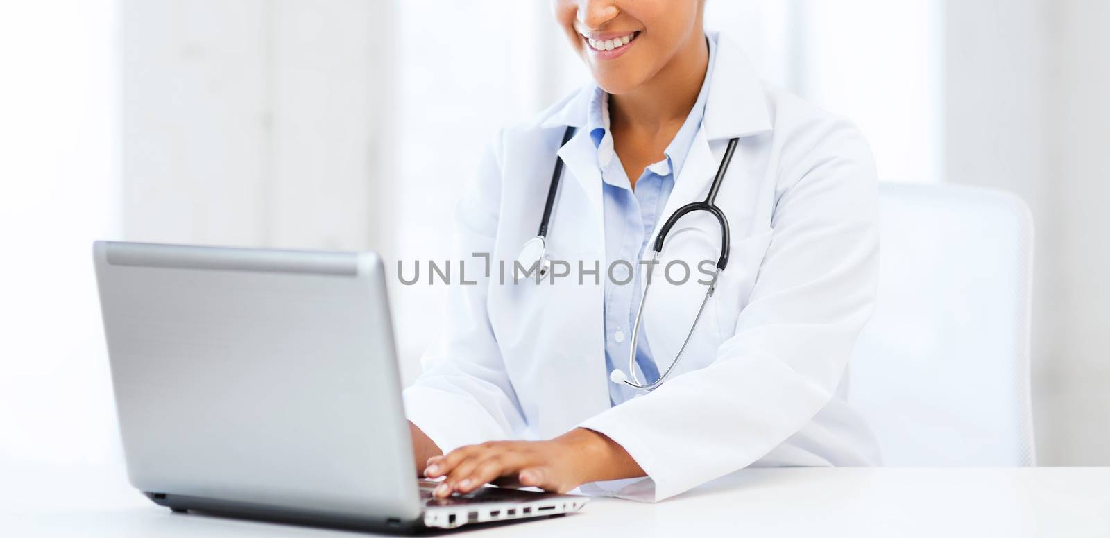 female doctor with laptop pc by dolgachov