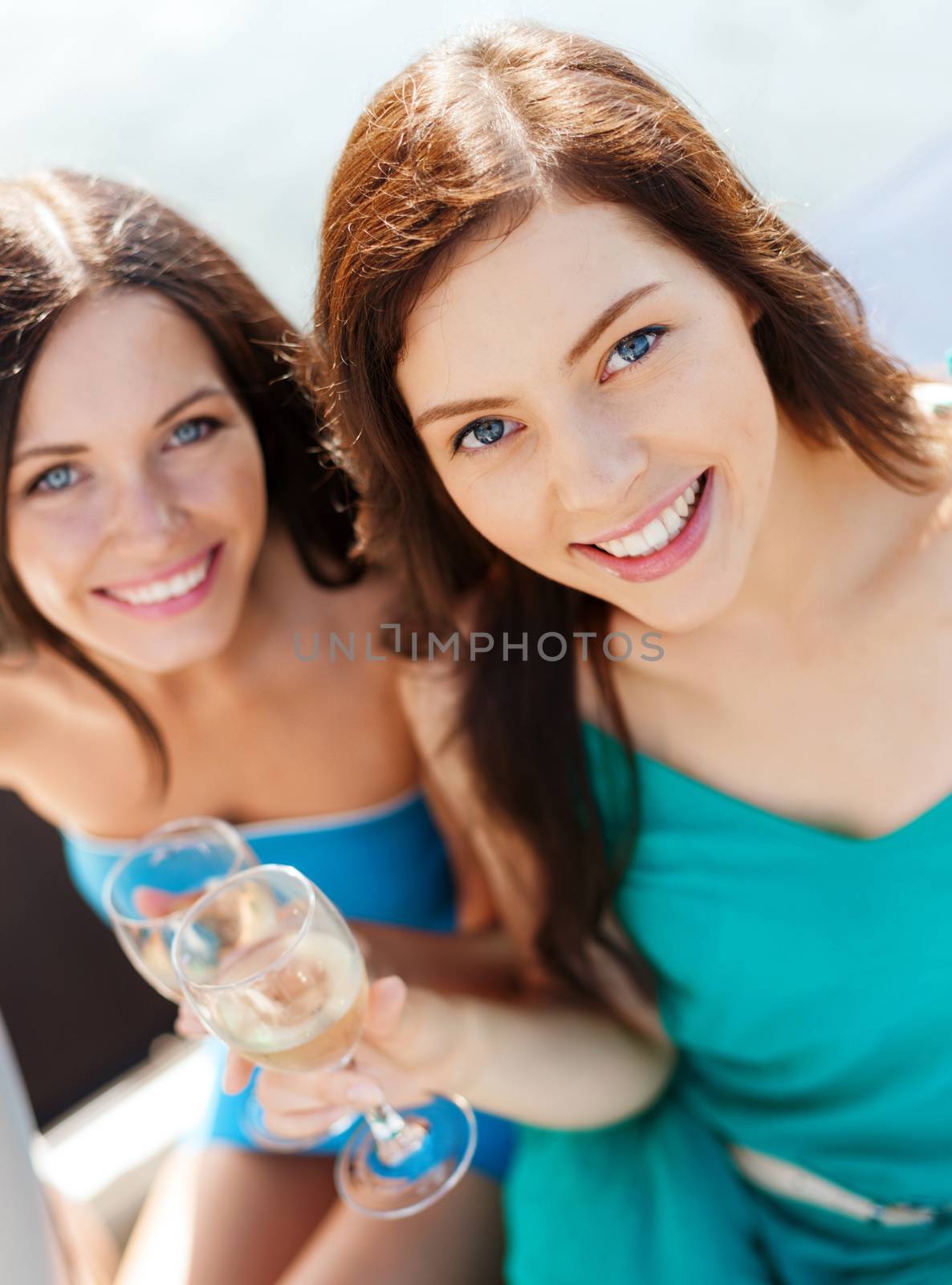 girls with champagne glasses on boat by dolgachov