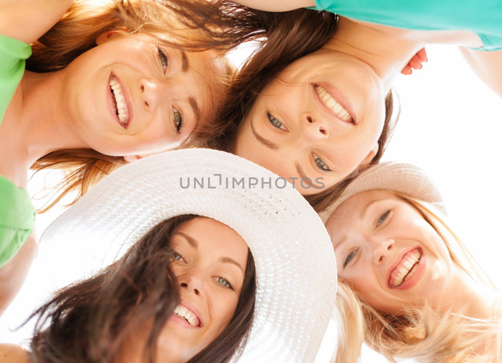 summer holidays and vacation concept - faces of girls looking down and smiling