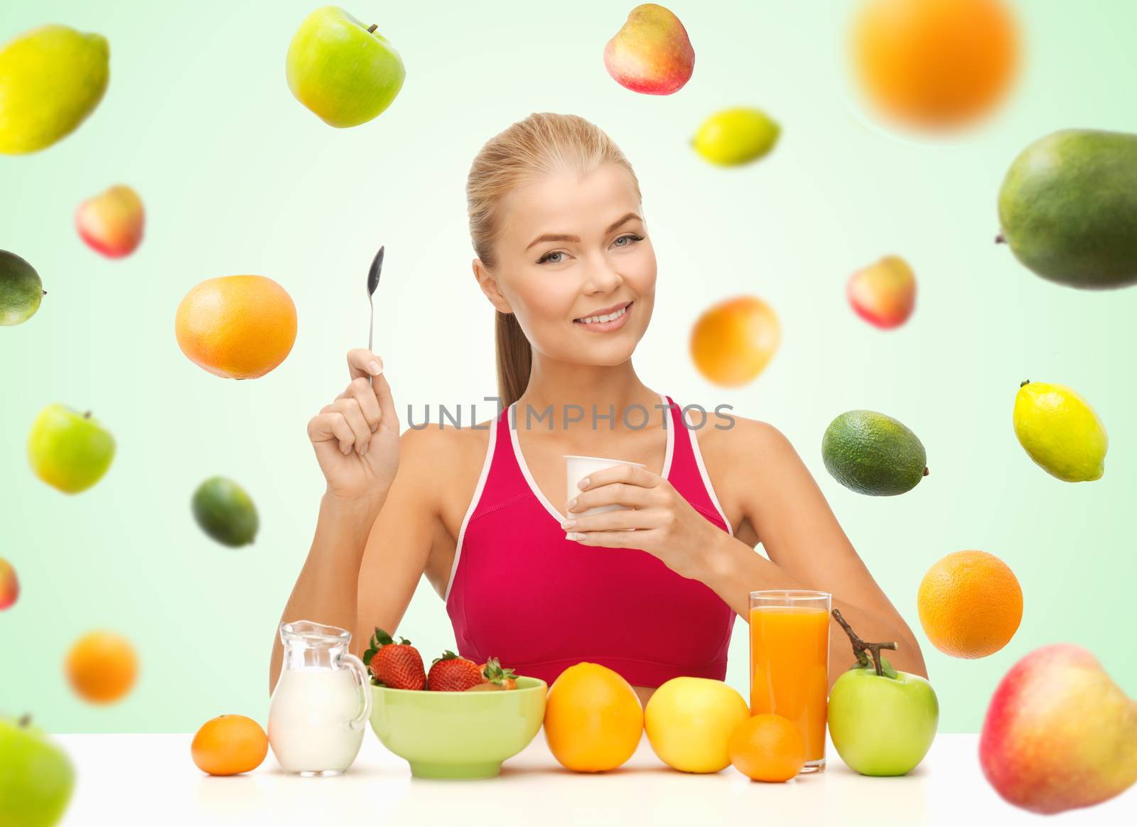 woman eating yogurt and having healthy breakfast by dolgachov