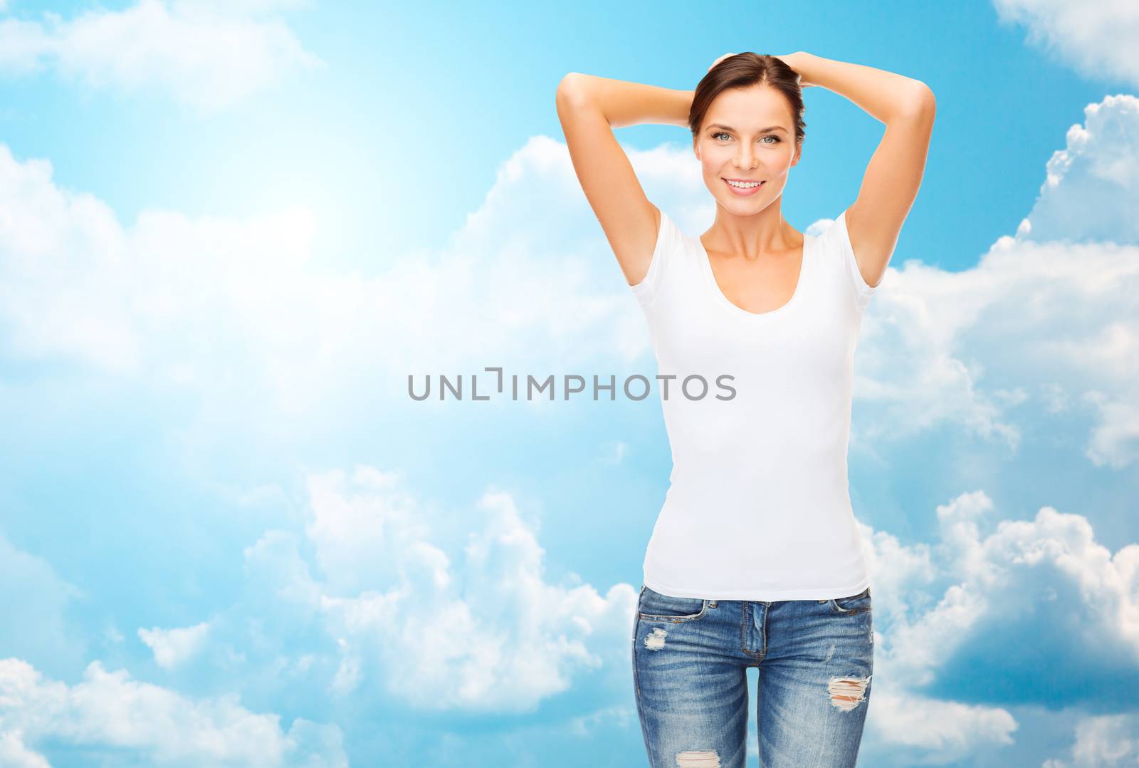 people, advertisement and clothing concept - happy woman in blank white t-shirt over blue sky with white clouds background