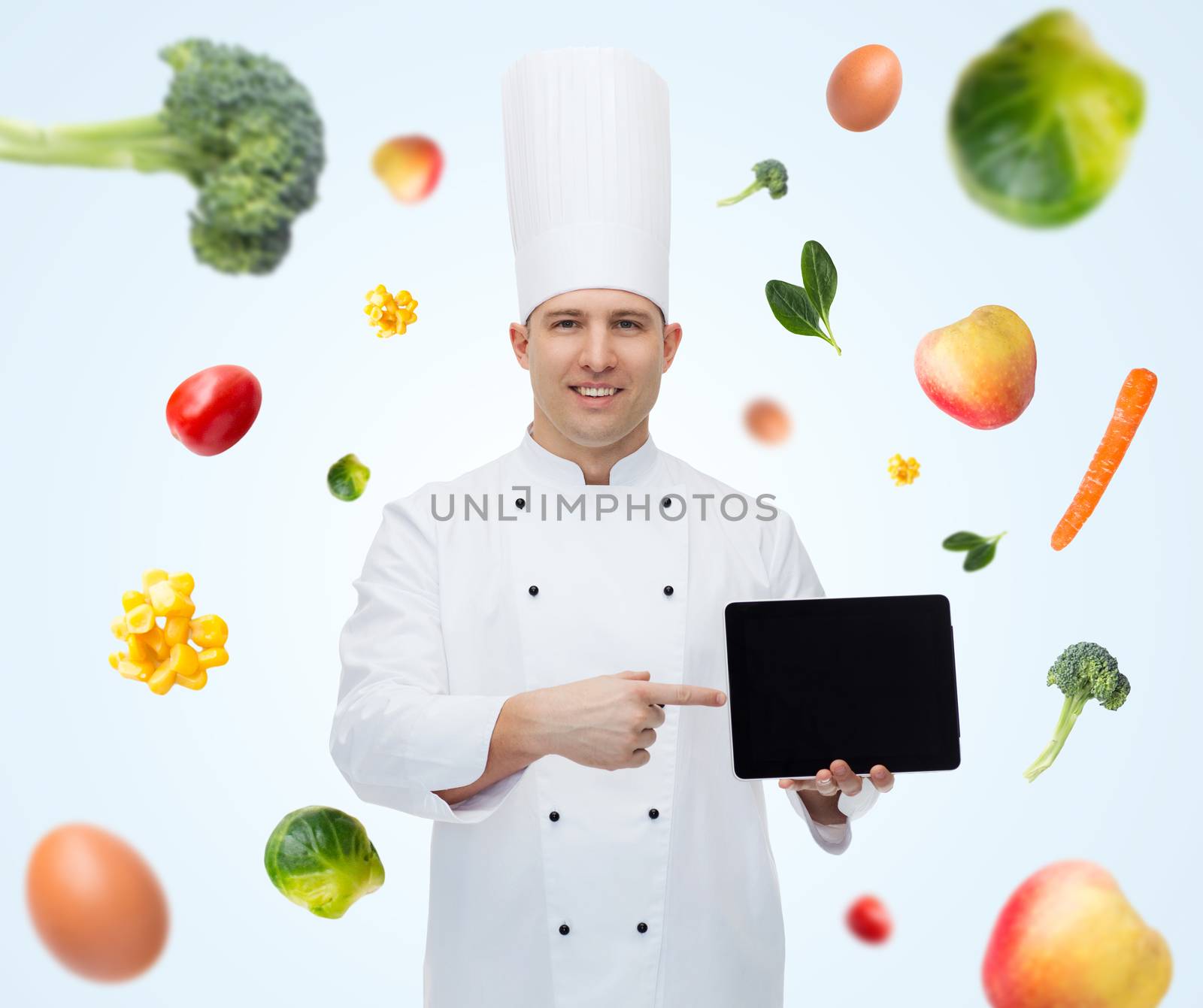 happy male chef cook showing with tablet pc by dolgachov