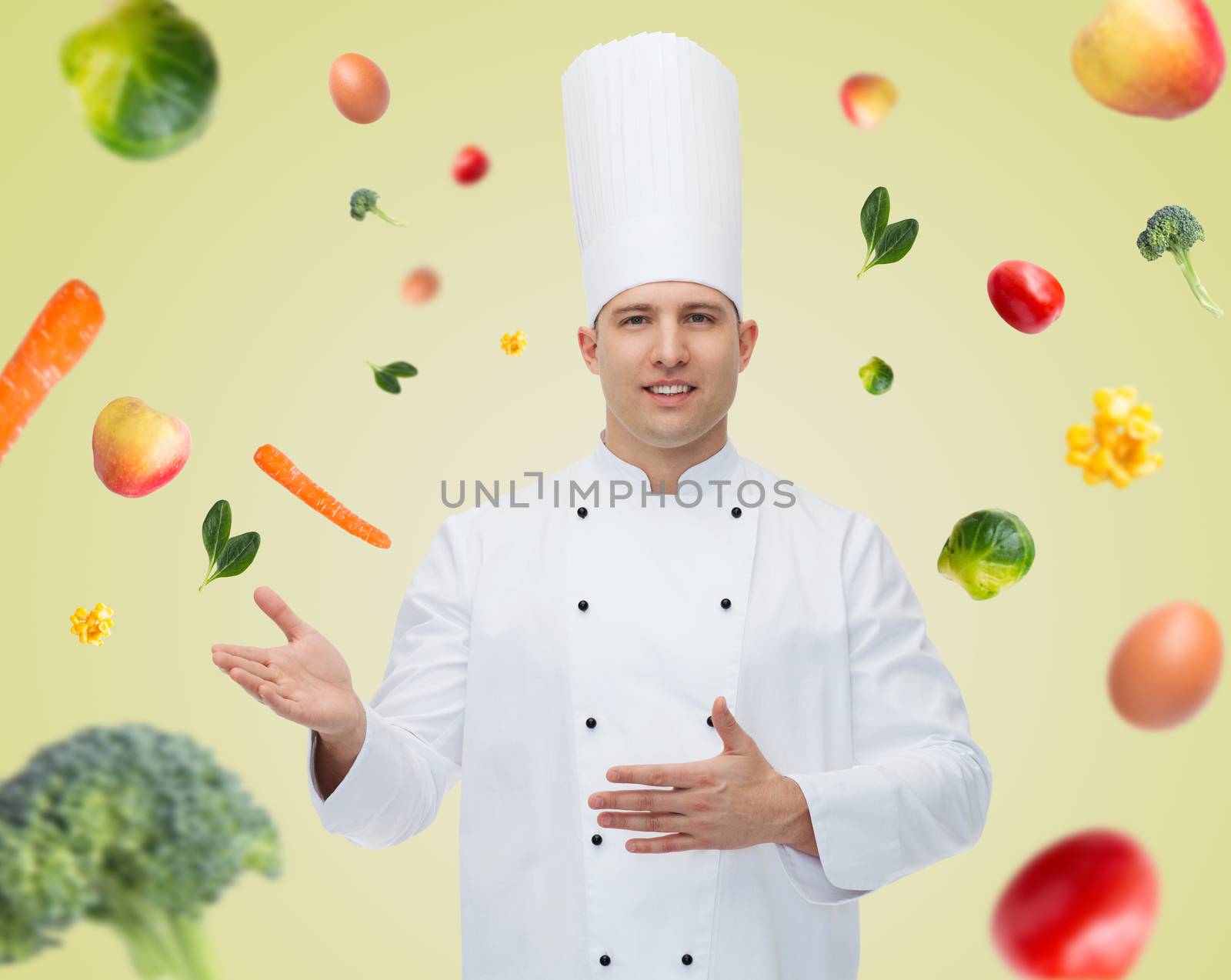 cooking, profession and people concept - happy male chef cook inviting