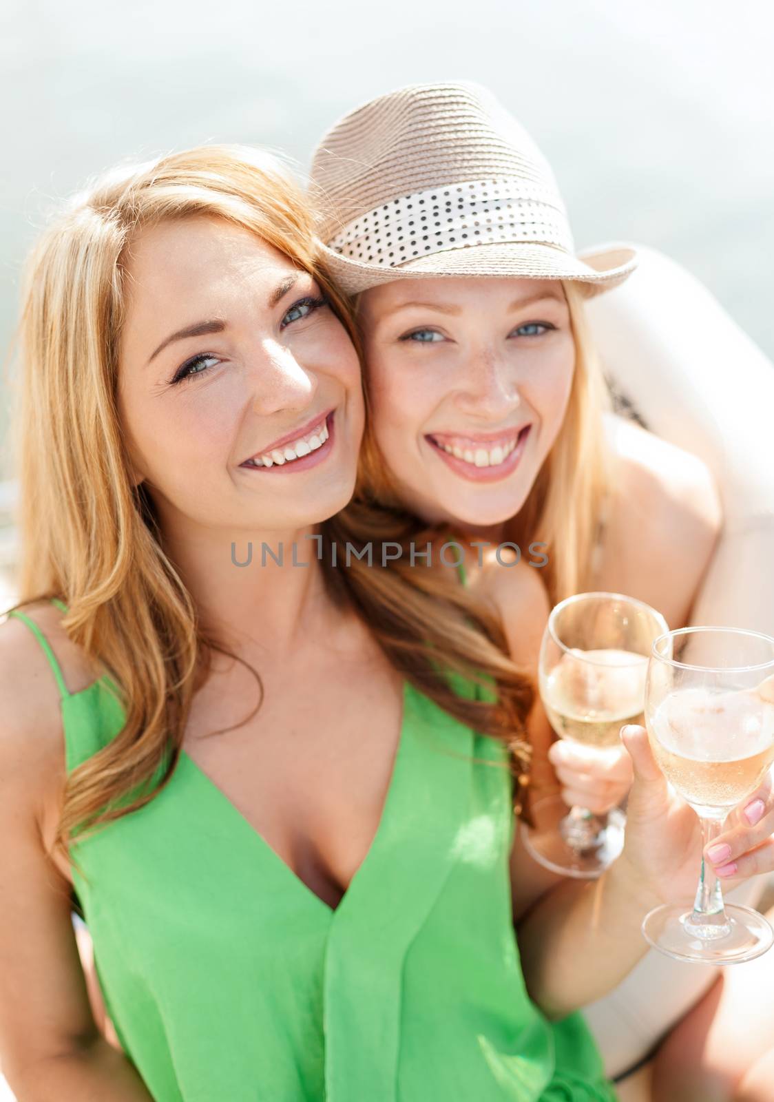 smiling girls with champagne glasses by dolgachov