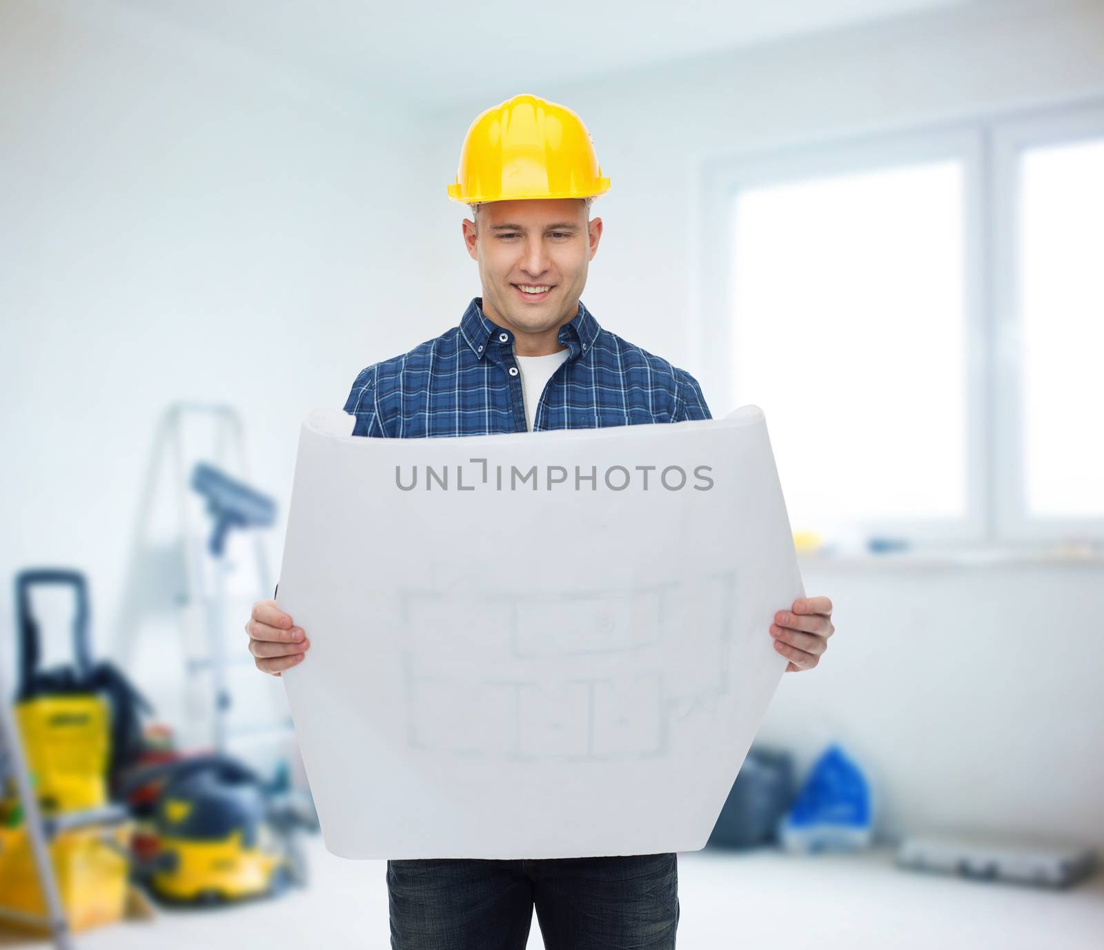 repair, construction, building, people and maintenance concept - smiling male builder or manual worker in helmet reading blueprint over room with work equipment background