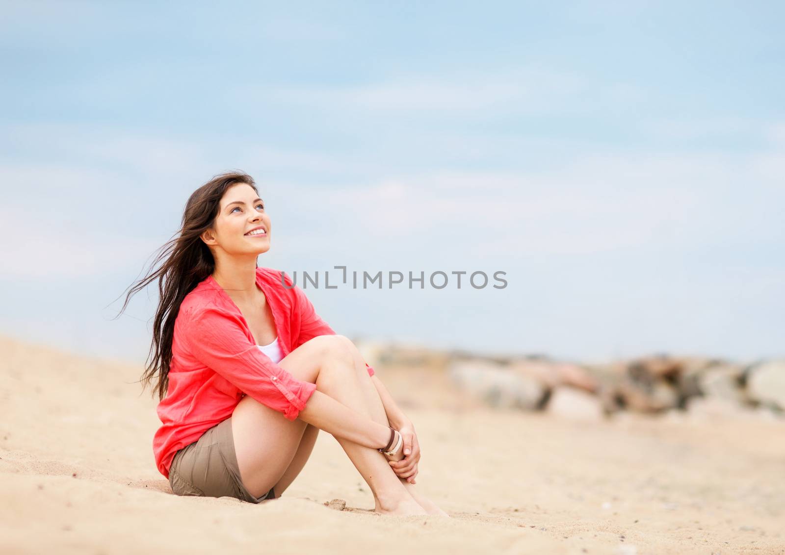 girl sitting on the beach by dolgachov