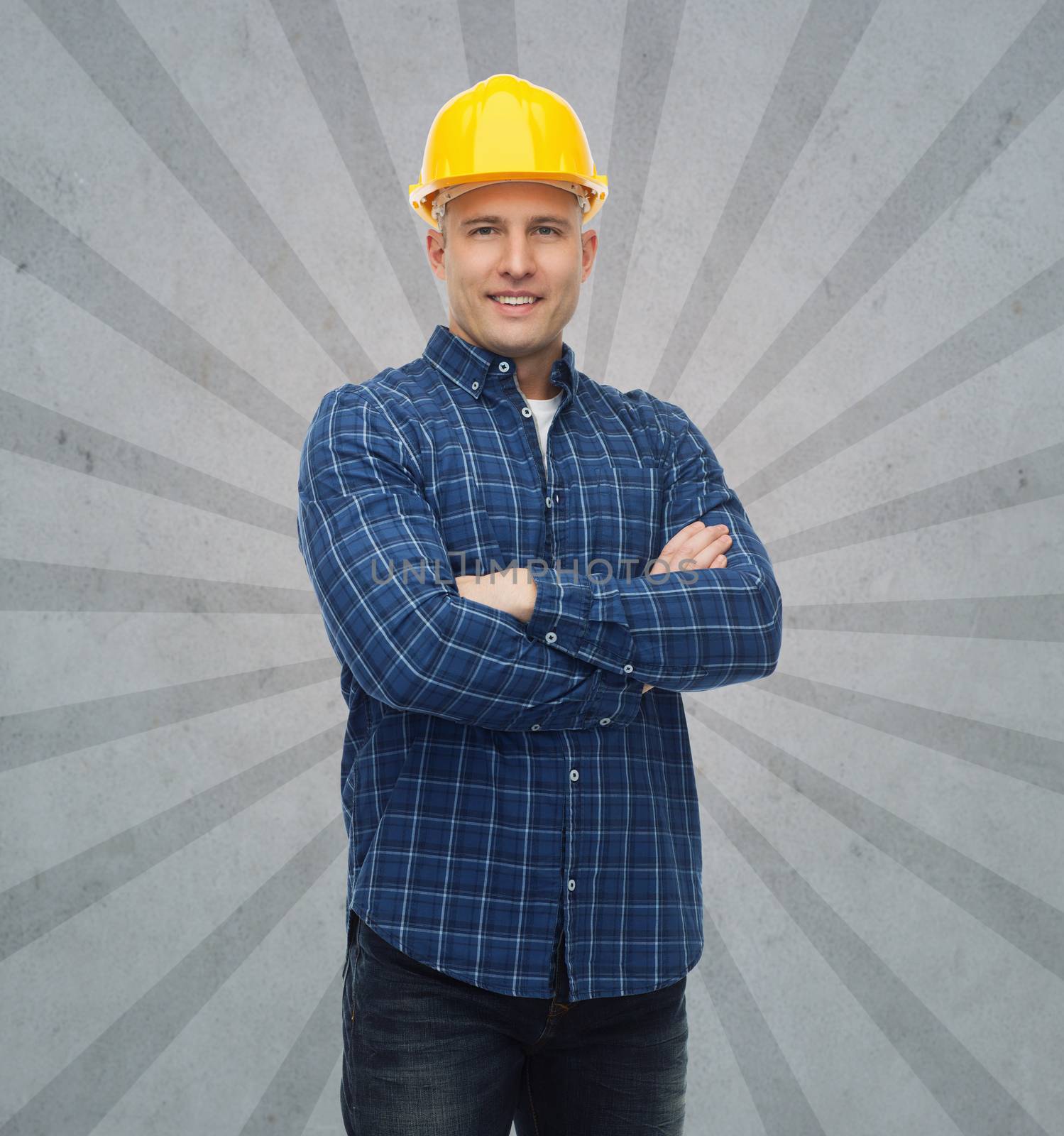 smiling male builder or manual worker in helmet by dolgachov
