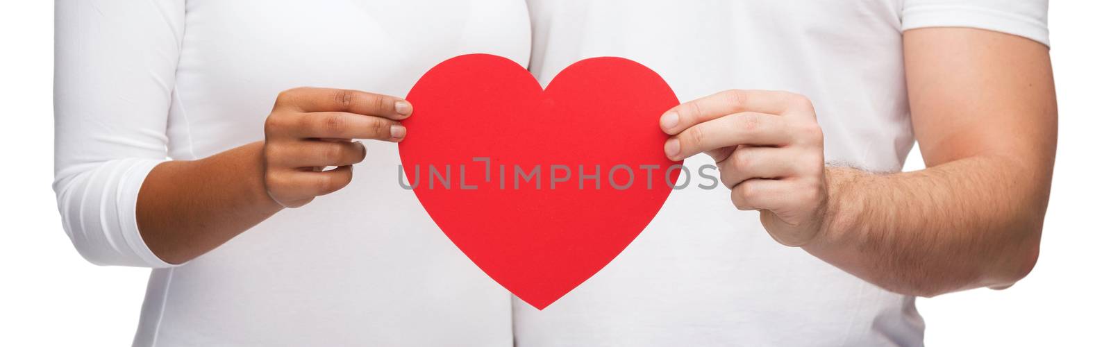 love and relationships concept - closeup of couple hands with heart