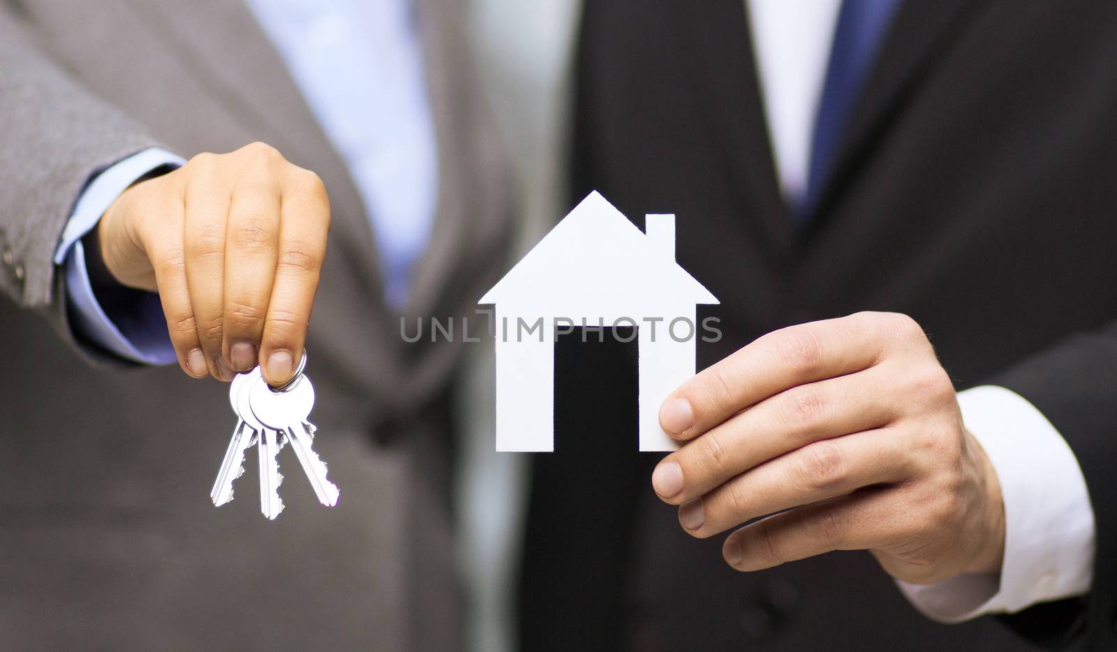 business, eco, real estate and office concept - businessman and businesswoman holding white paper house and keys in office