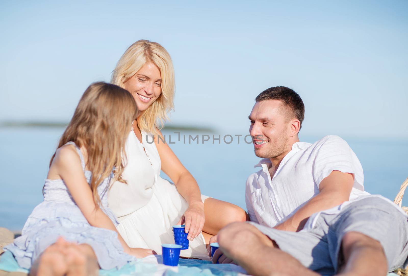 happy family having a picnic by dolgachov