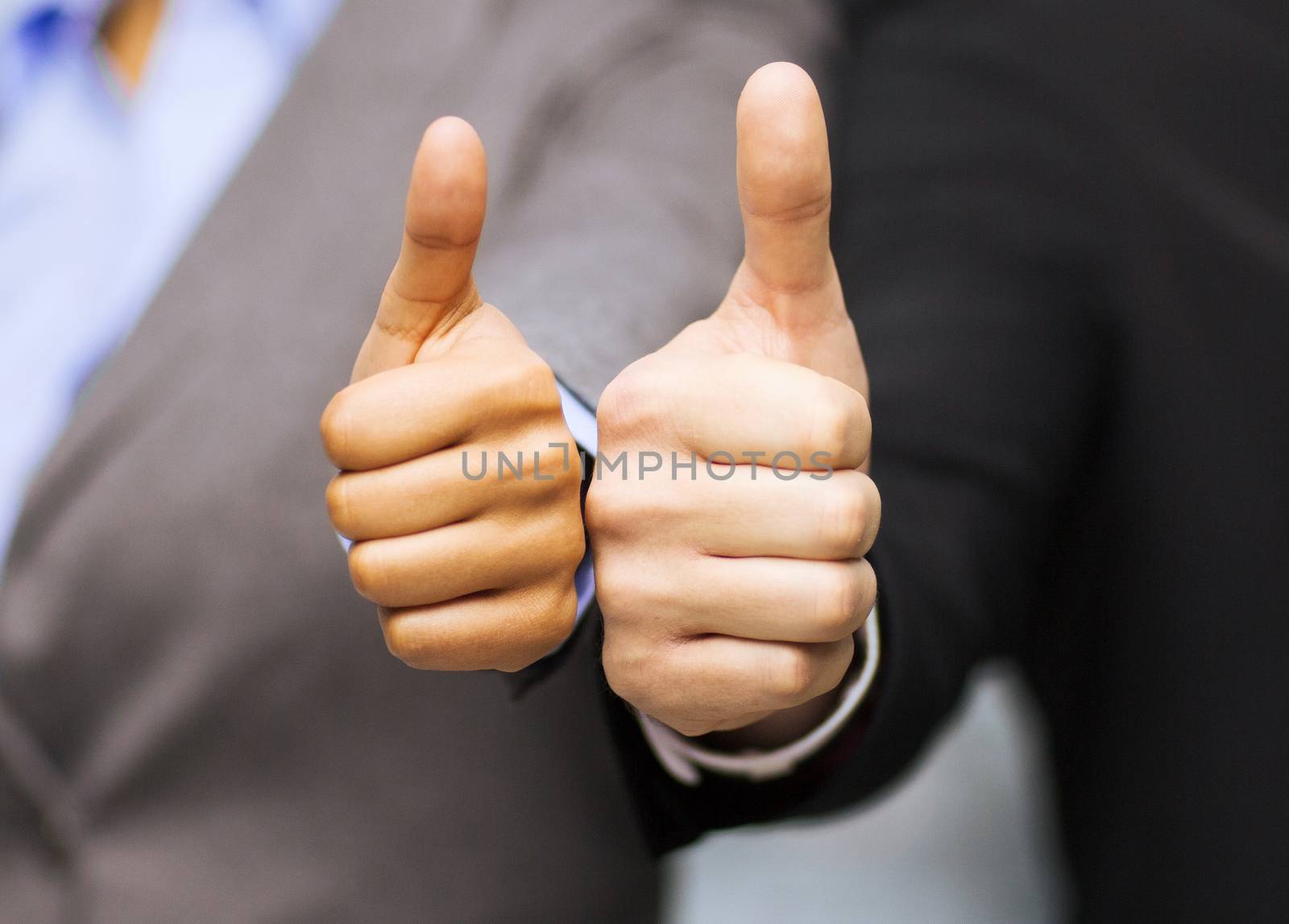 businessman and businesswoman showing thumbs up by dolgachov