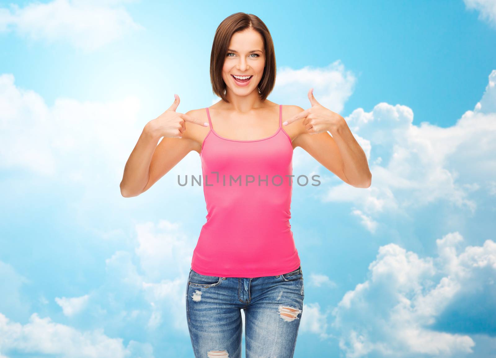 people, advertisement and clothing concept - smiling woman in blank pink tank top pointing fingers to herself over blue sky with white clouds background