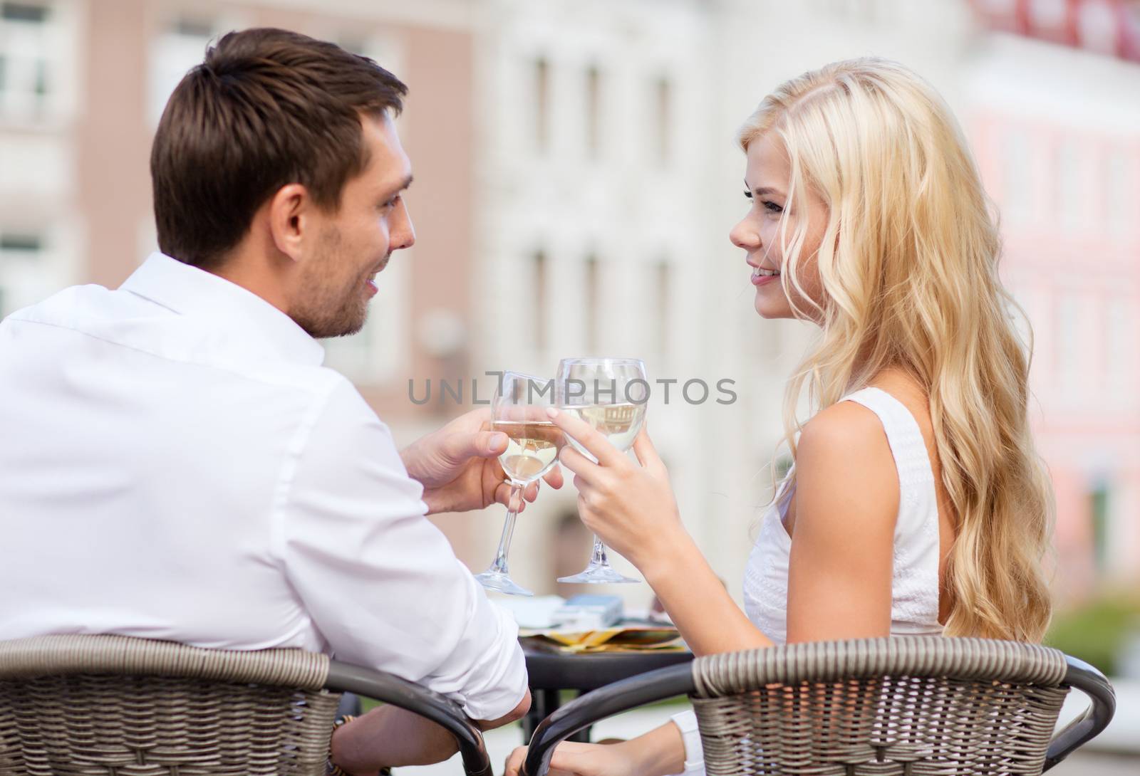 couple drinking wine in cafe by dolgachov