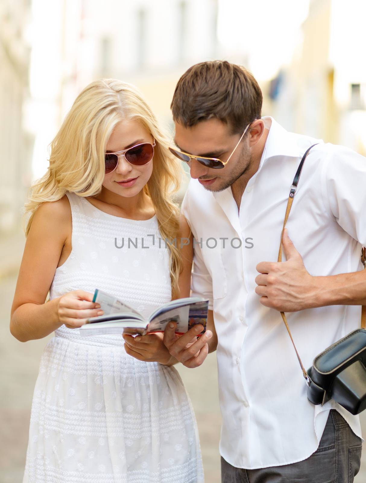 summer holidays, dating, city break and tourism concept - couple with map, camera and travellers guide