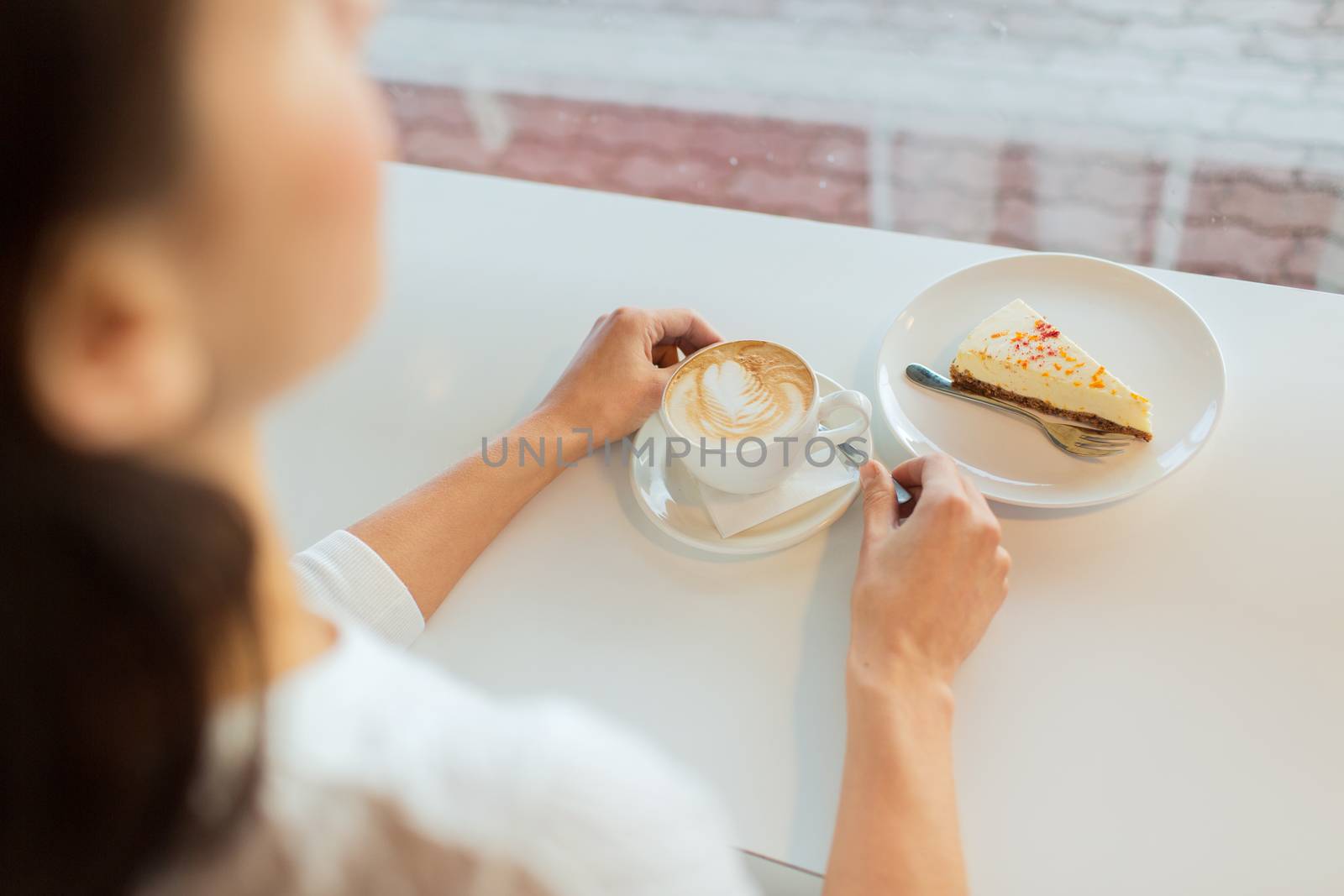 close up of woman hands with cake and coffee by dolgachov