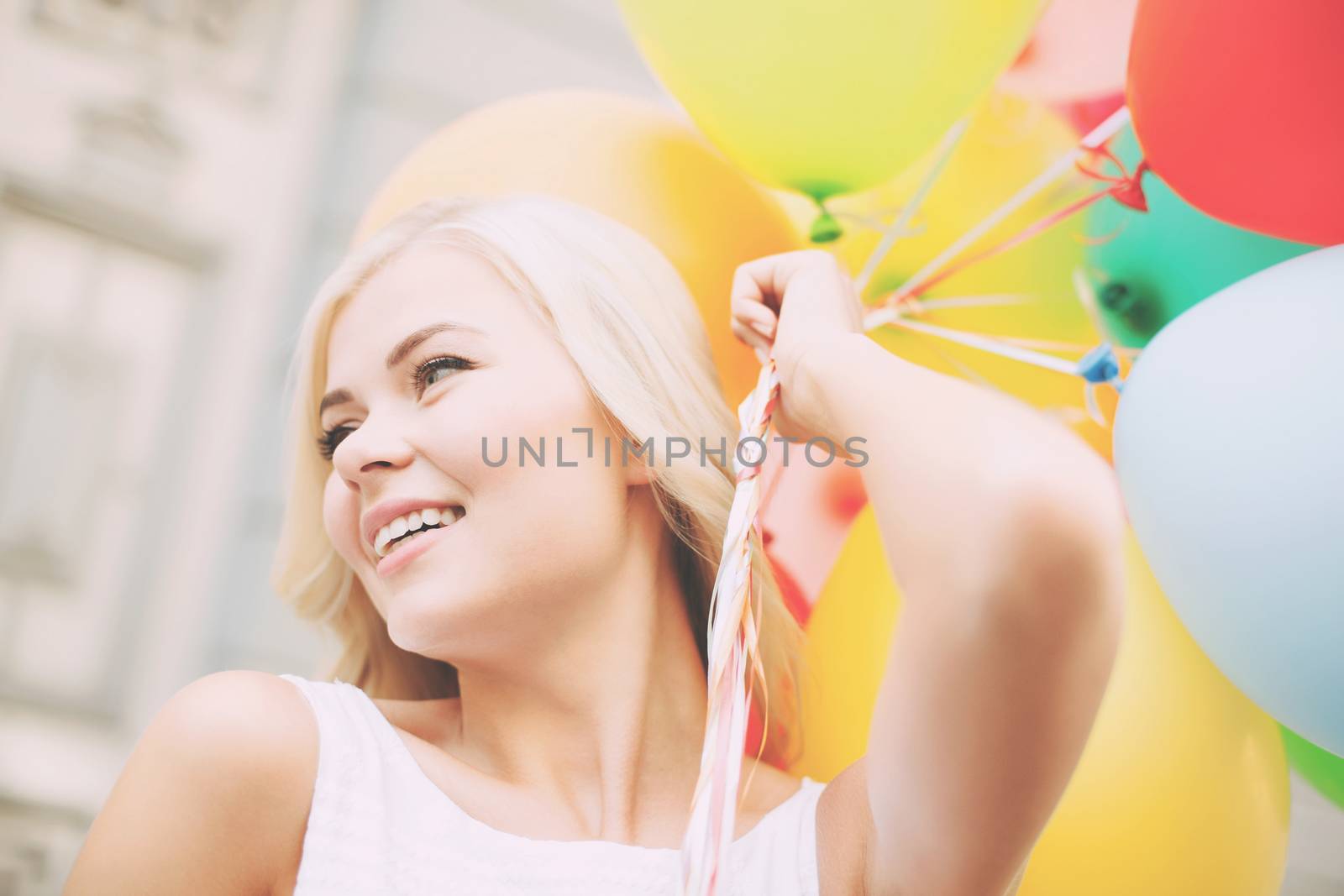 summer holidays, celebration and lifestyle concept - beautiful woman with colorful balloons in the city