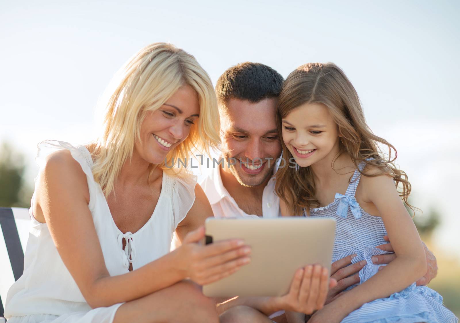 summer holidays, children and people concept - happy family with tablet pc taking picture