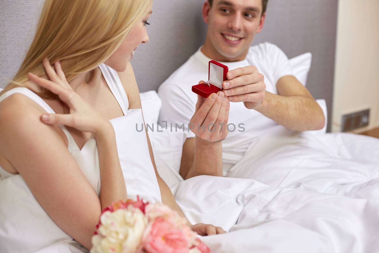 close up of man giving woman engagement ring by dolgachov