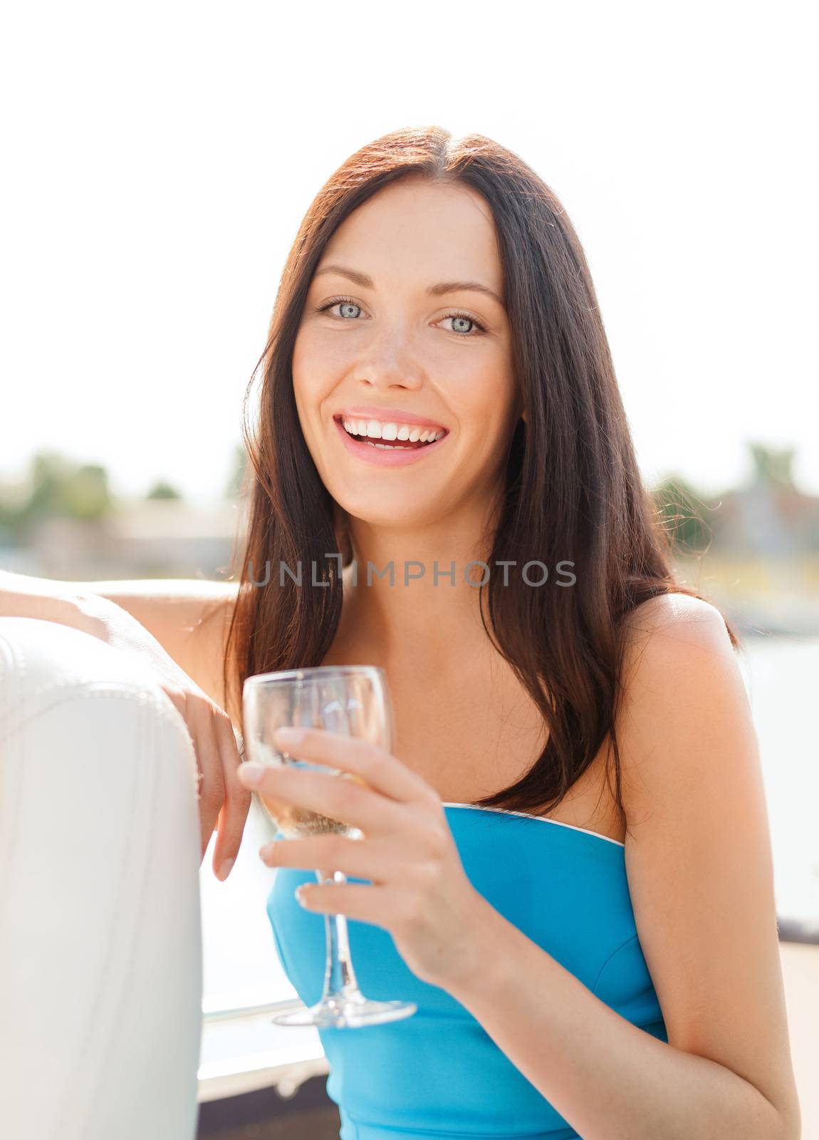 summer holidays, vacation and celebration concept - laughing girl with champagne glass