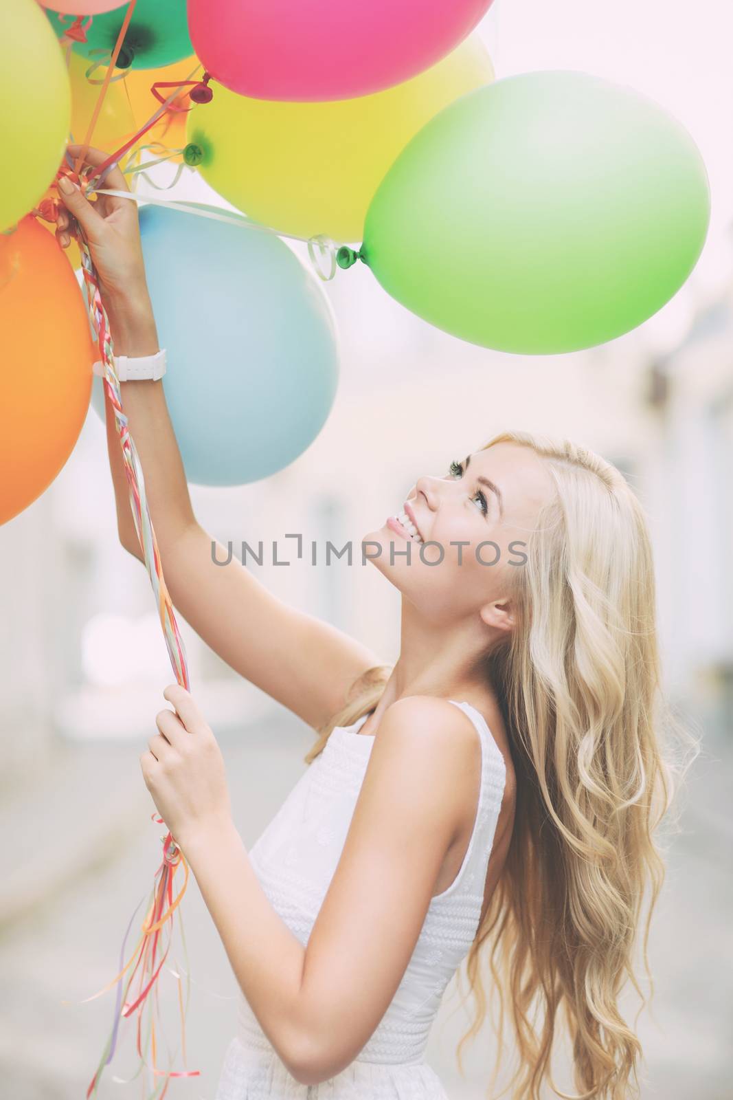 summer holidays, celebration and lifestyle concept - beautiful woman with colorful balloons in the city