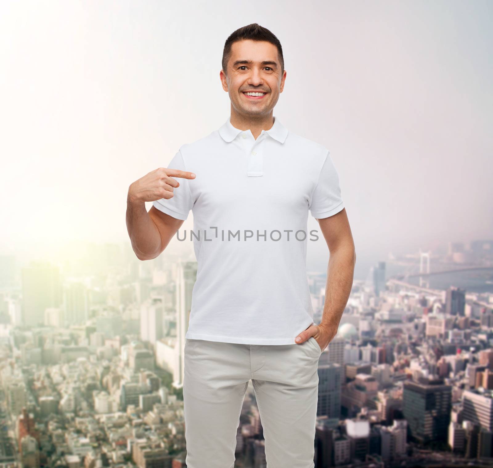smiling man in t-shirt pointing finger on himself by dolgachov