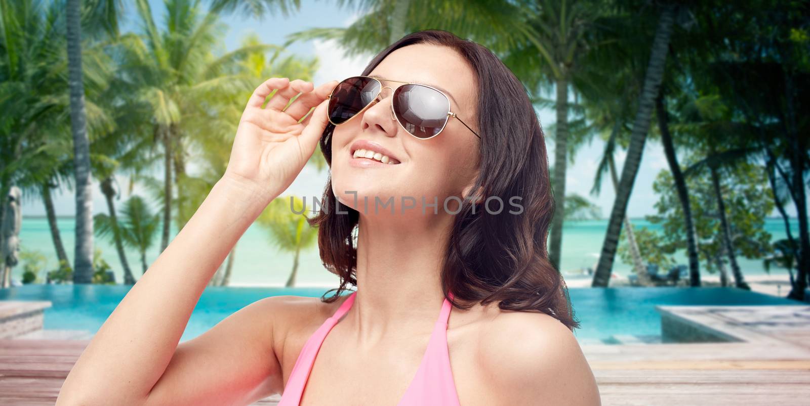happy woman in sunglasses and swimsuit by dolgachov