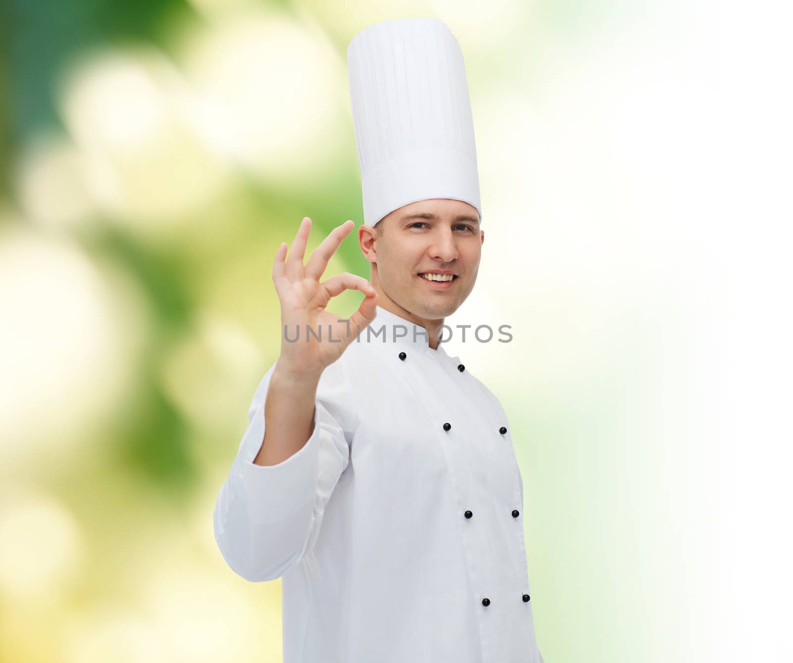 cooking, profession, gesture and people concept - happy male chef cook showing ok sign over green background