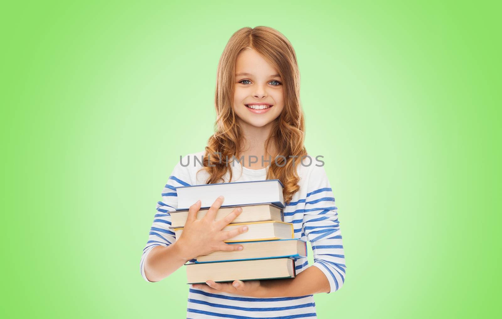 education, people, children and school concept - happy little student girl with many books over green background