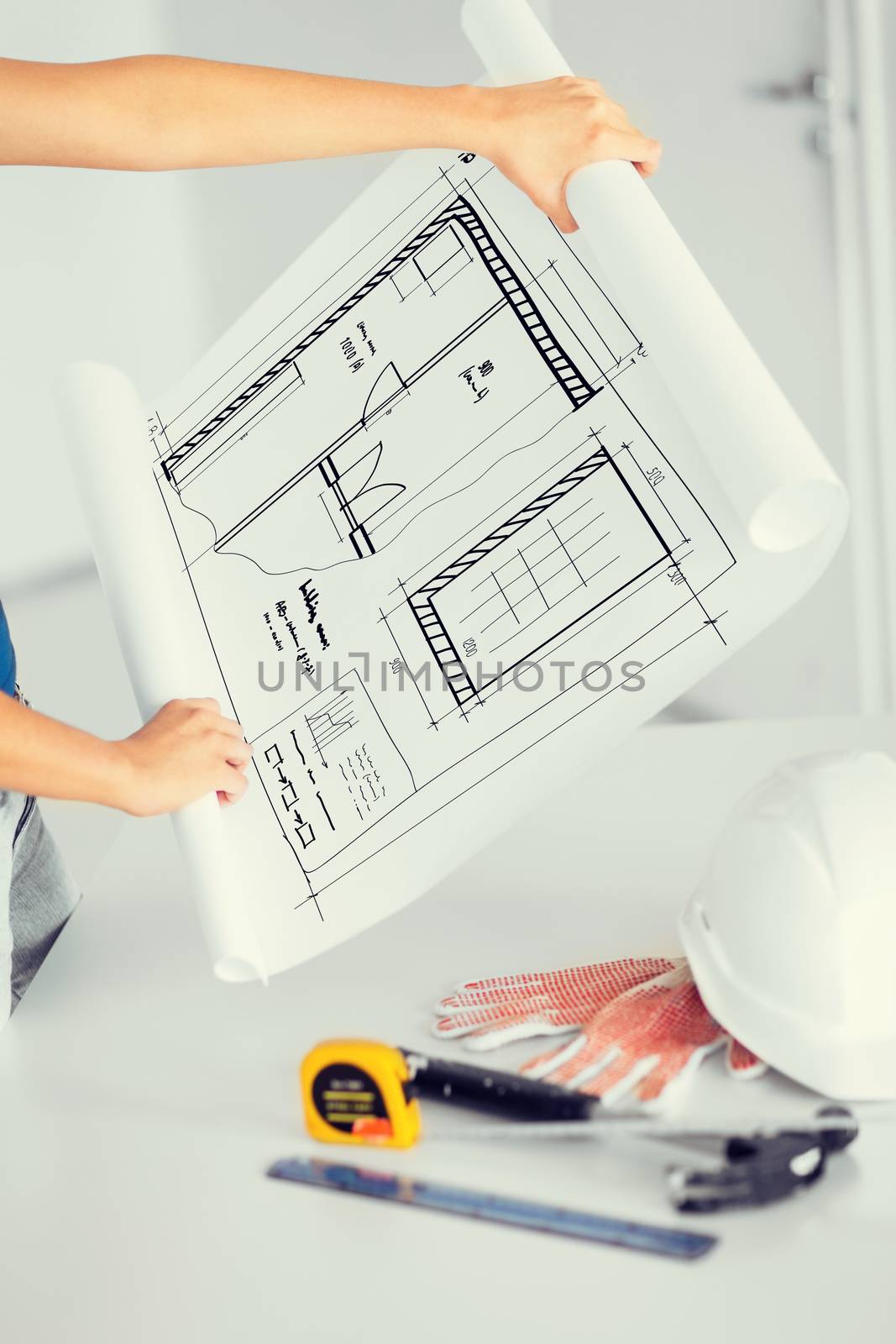 architecture and home renovation concept - woman with blueprint, flexible ruller, helmet and hammer