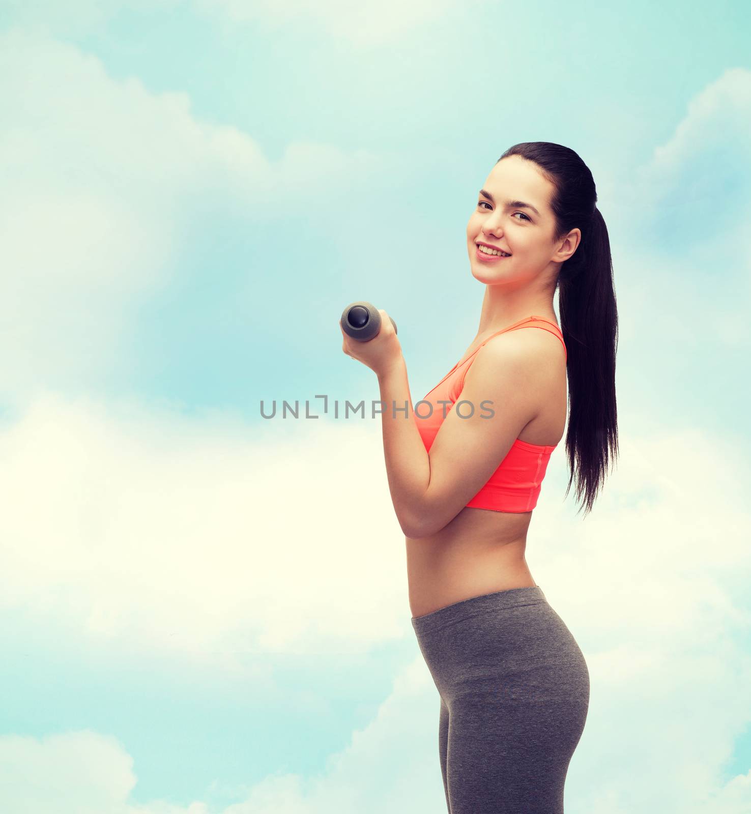 young sporty woman with light dumbbells by dolgachov