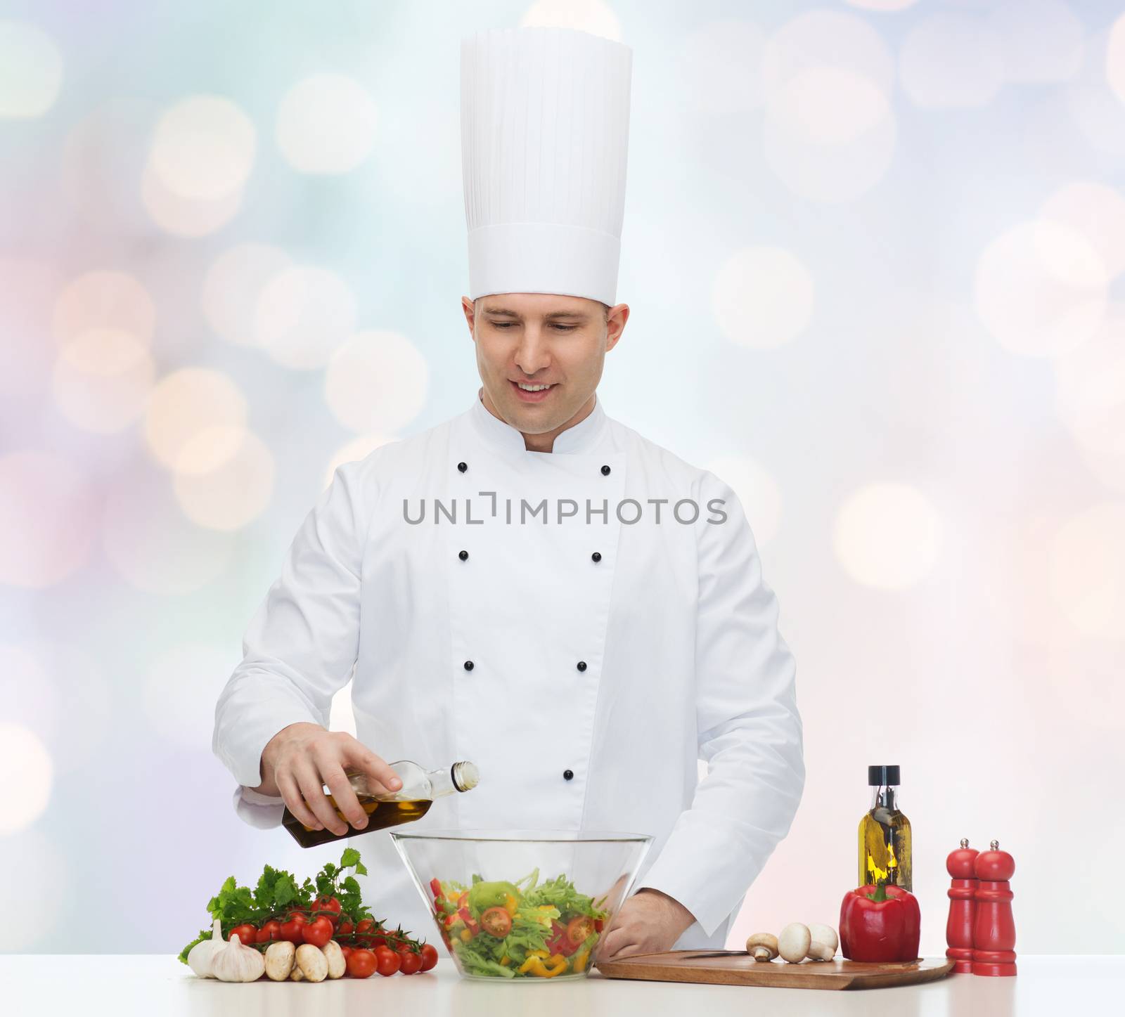 profession, vegetarian, food and people concept - happy male chef cooking salad over blue lights background