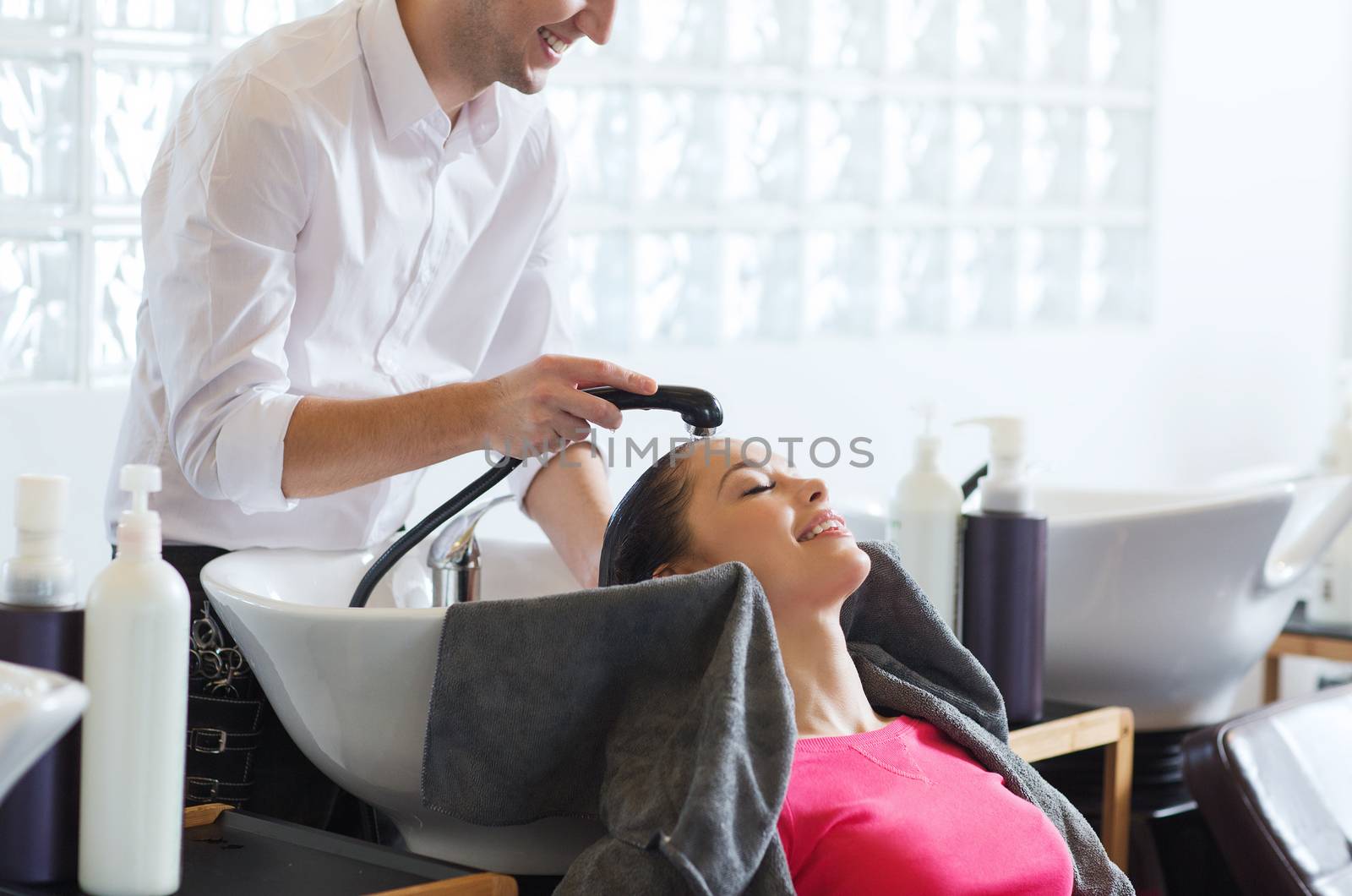 happy young woman at hair salon by dolgachov