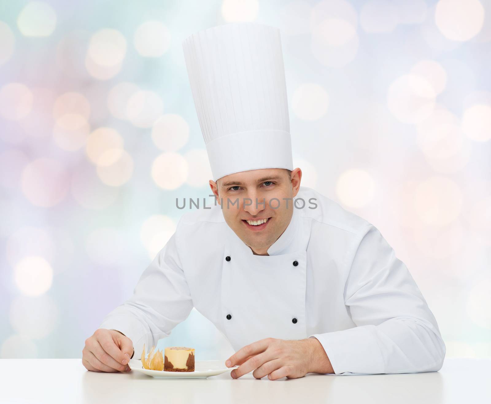 cooking, profession, haute cuisine, food and people concept - happy male chef cook with dessert over blue lights background