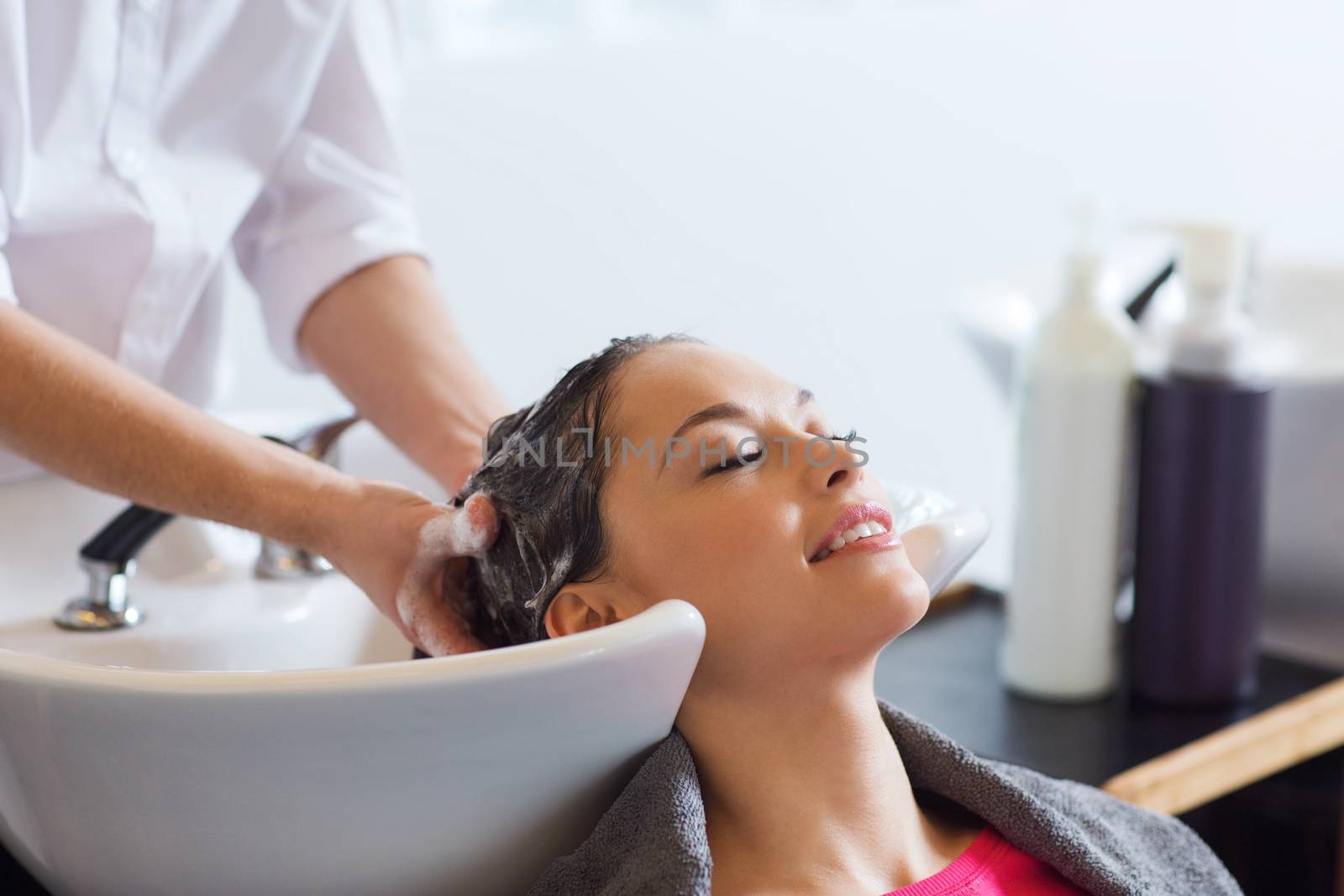 happy young woman at hair salon by dolgachov