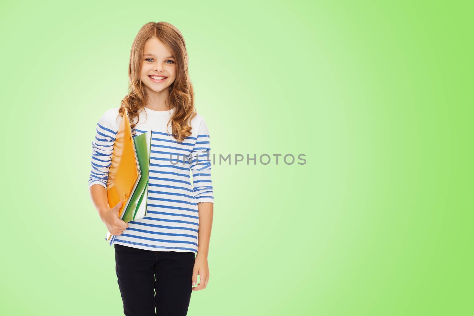 education, people, children and school concept - happy girl holding colorful folders over green background
