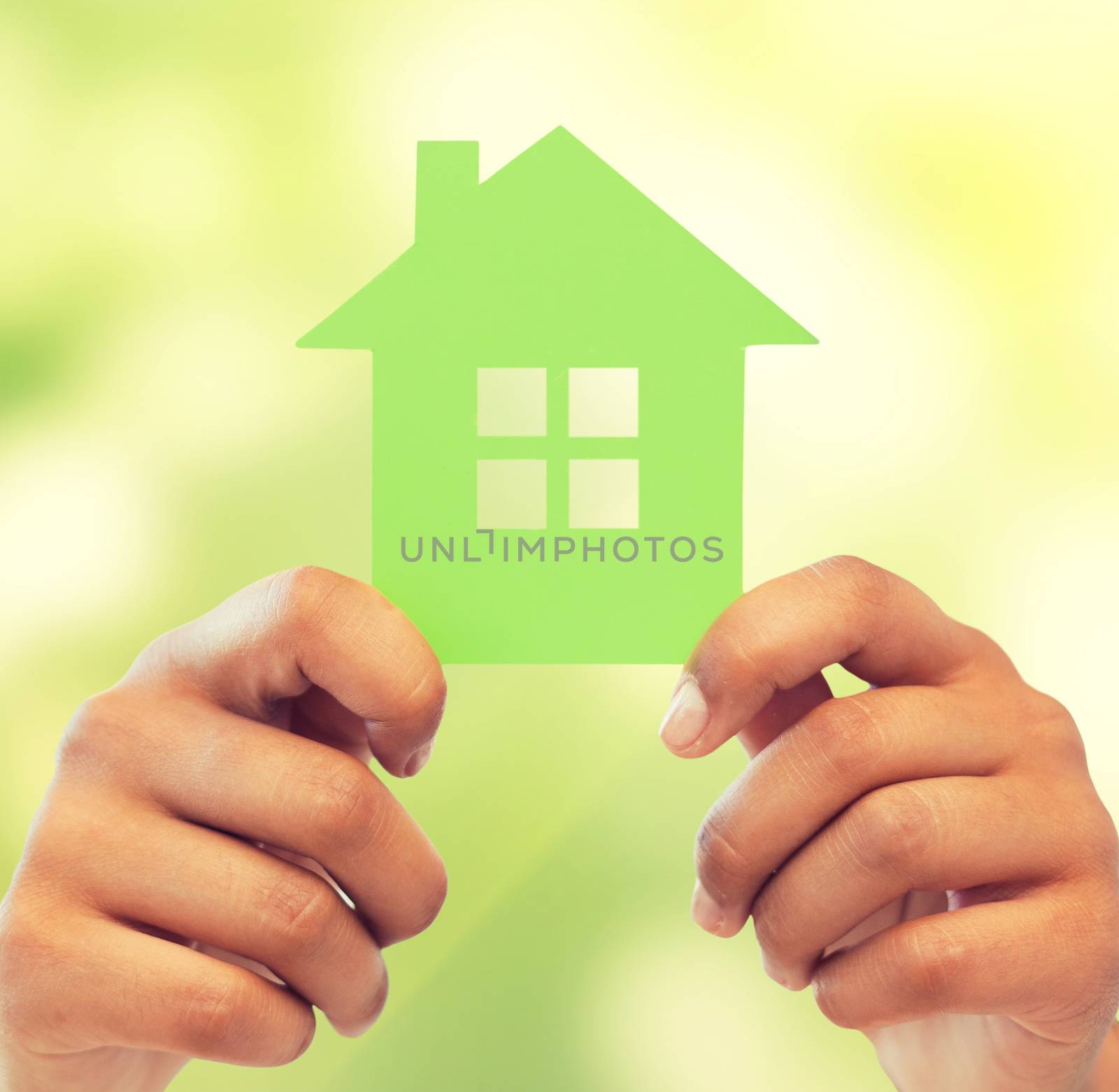 business, eco and real estate concept - closeup picture of woman hands holding green house