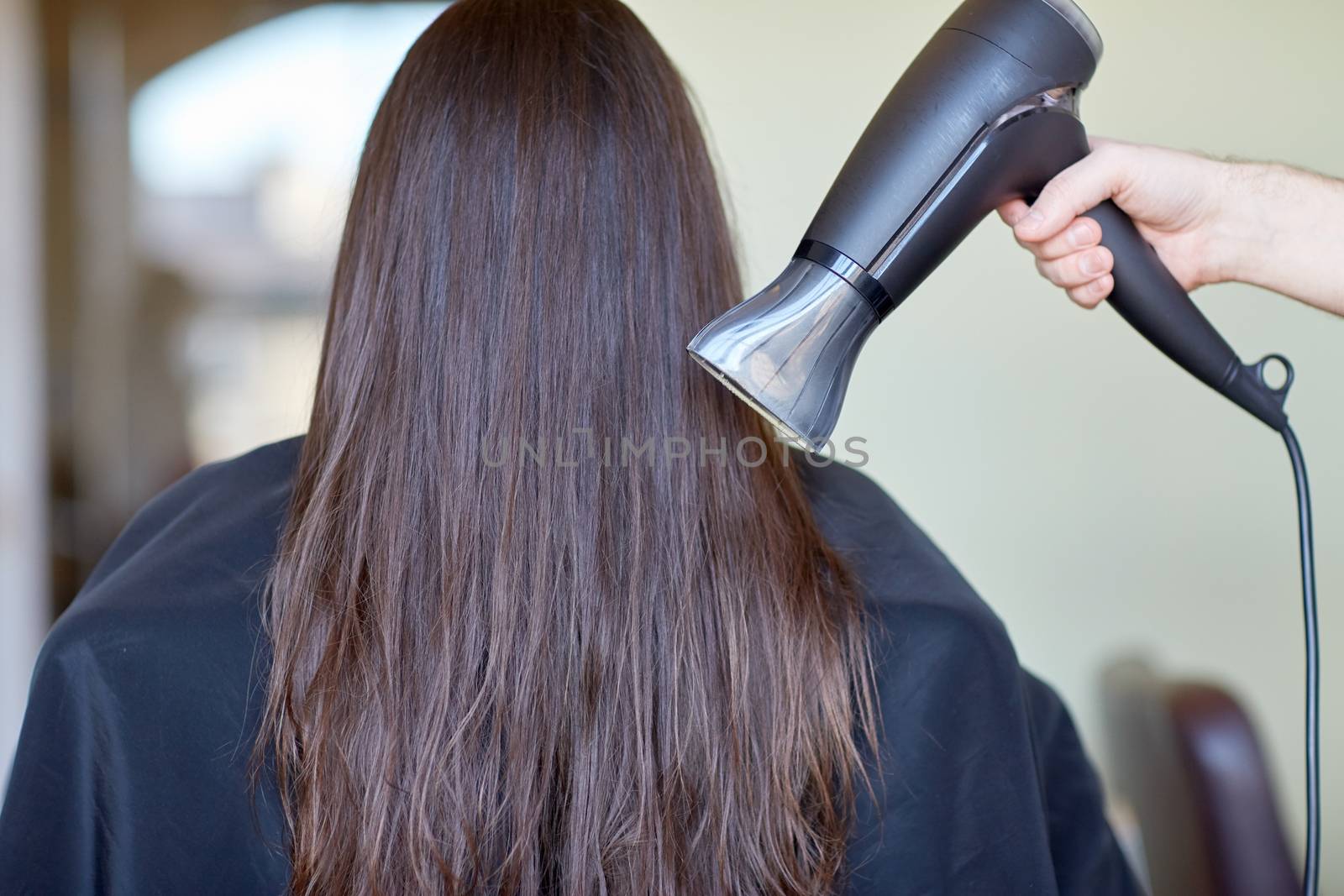 beauty, haircare, blow-dry, hairstyle and people concept - stylist hand with fan dries woman hair at salon