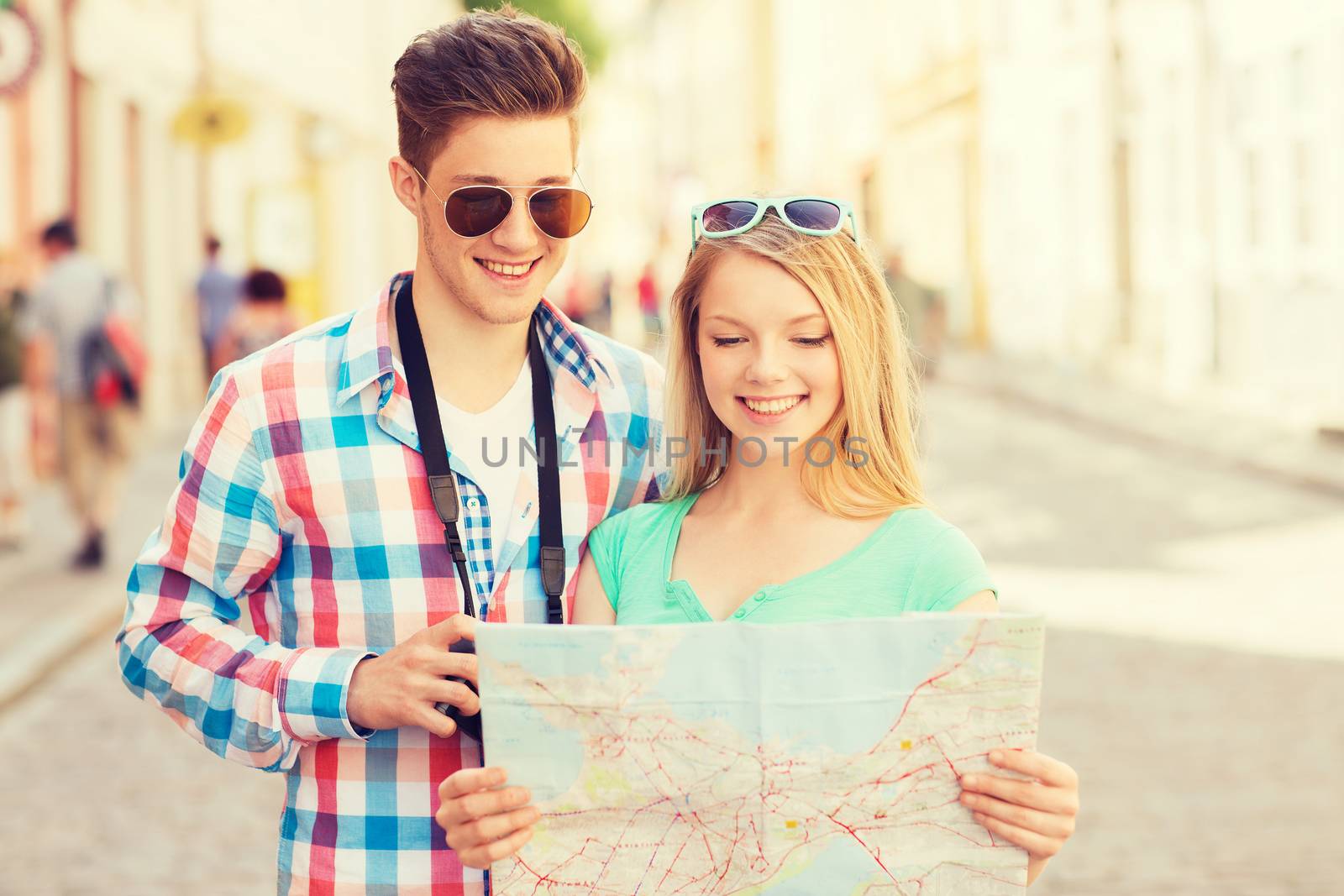 travel, vacation, technology and friendship concept - smiling couple with map and photo camera exploring city