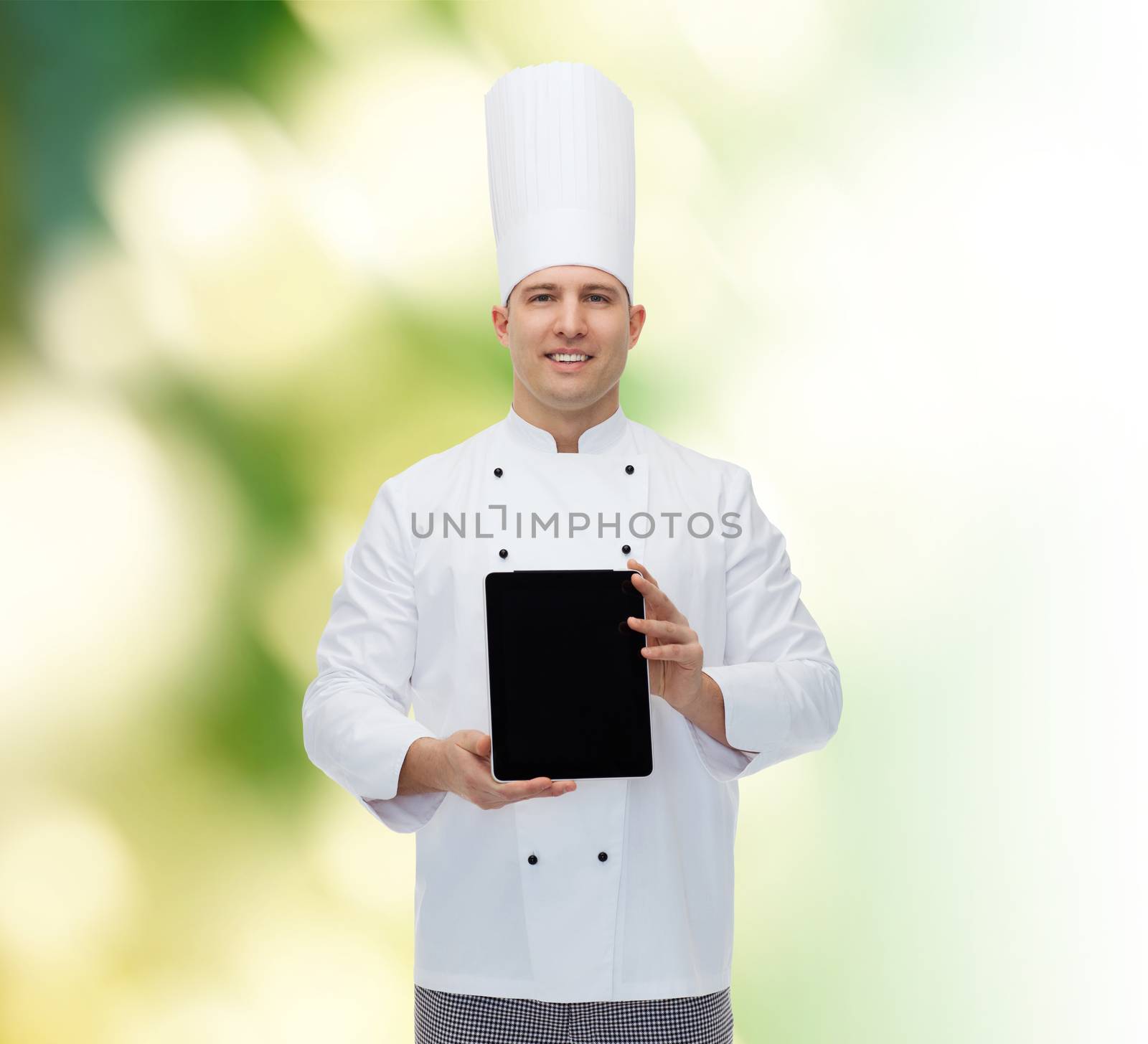 cooking, profession and people concept - happy male chef cook showing tablet pc computer black blank screen over green background