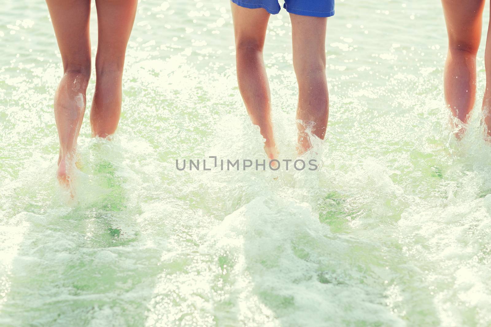 close up of human legs on summer beach by dolgachov
