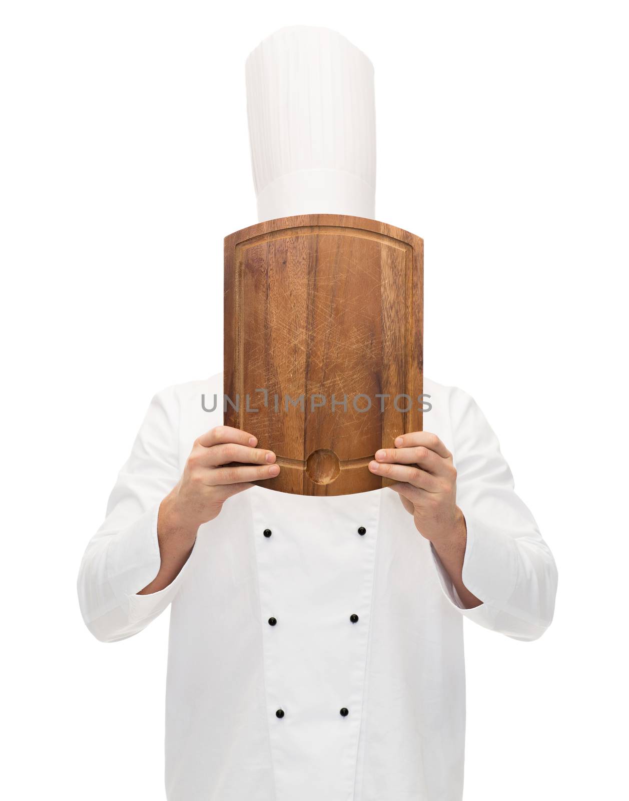 cooking, profession and people concept - male chef cook covering face or hiding behind wooden cutting board