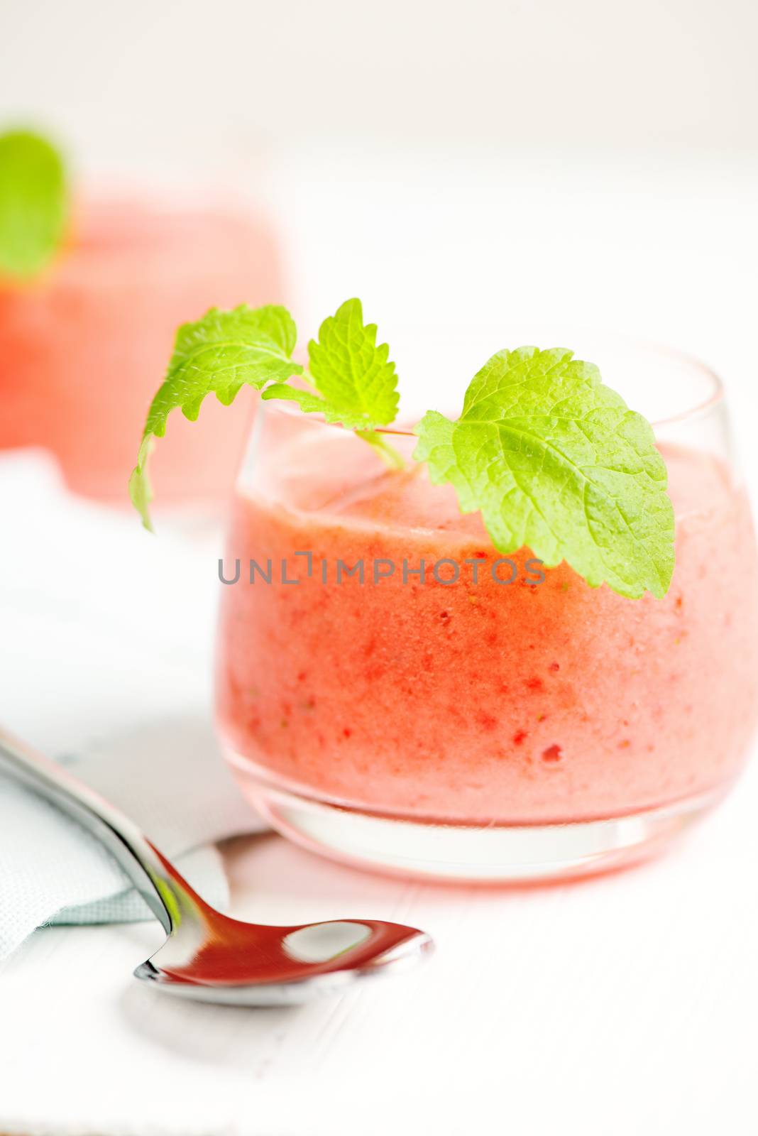 Smoothie drink with mint on table, in high key by Nanisimova