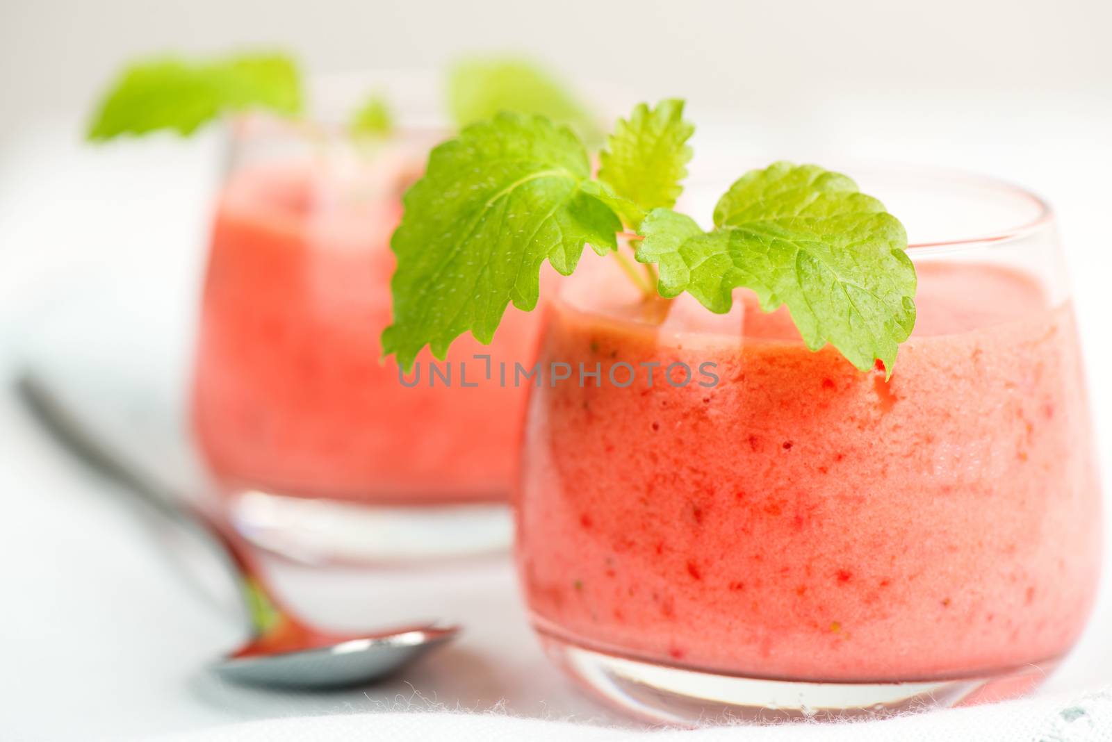 Smoothie drink with mint on table, in high key by Nanisimova