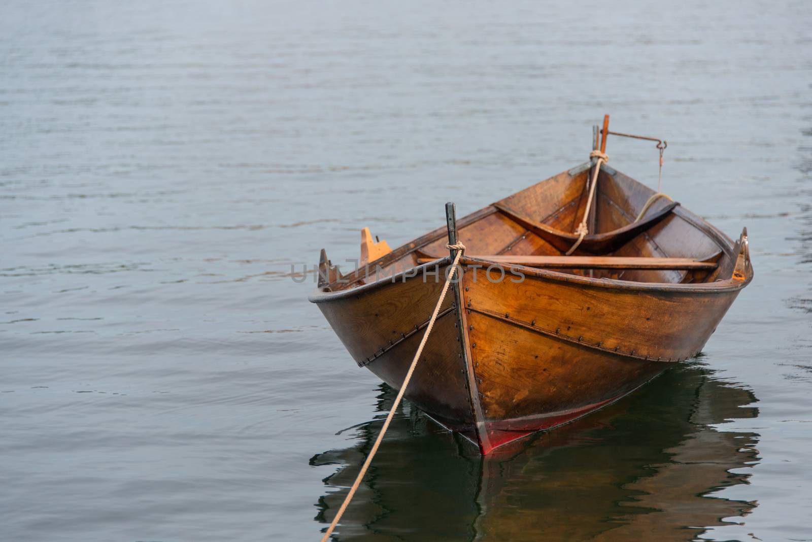 Old wooden row boat moored