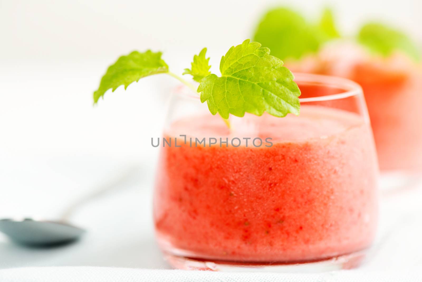 Smoothie drink with mint on table, in high key by Nanisimova