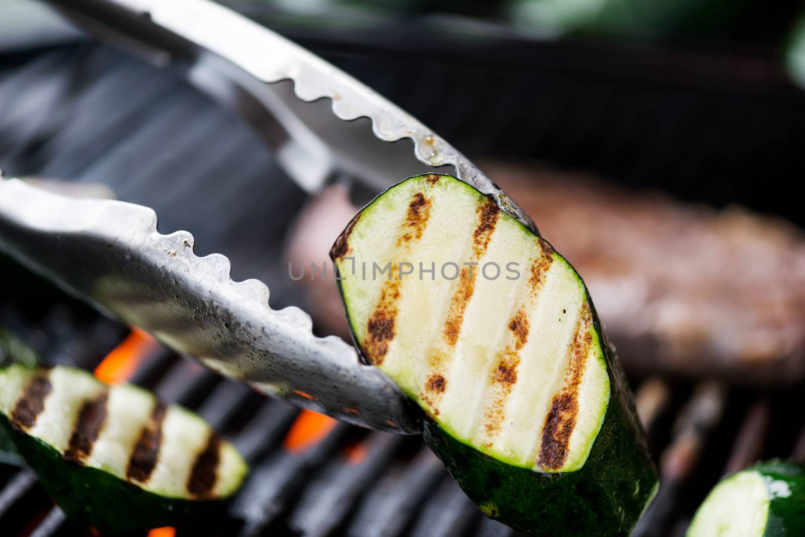 Cooking aubergine or eggplant on grill by Nanisimova