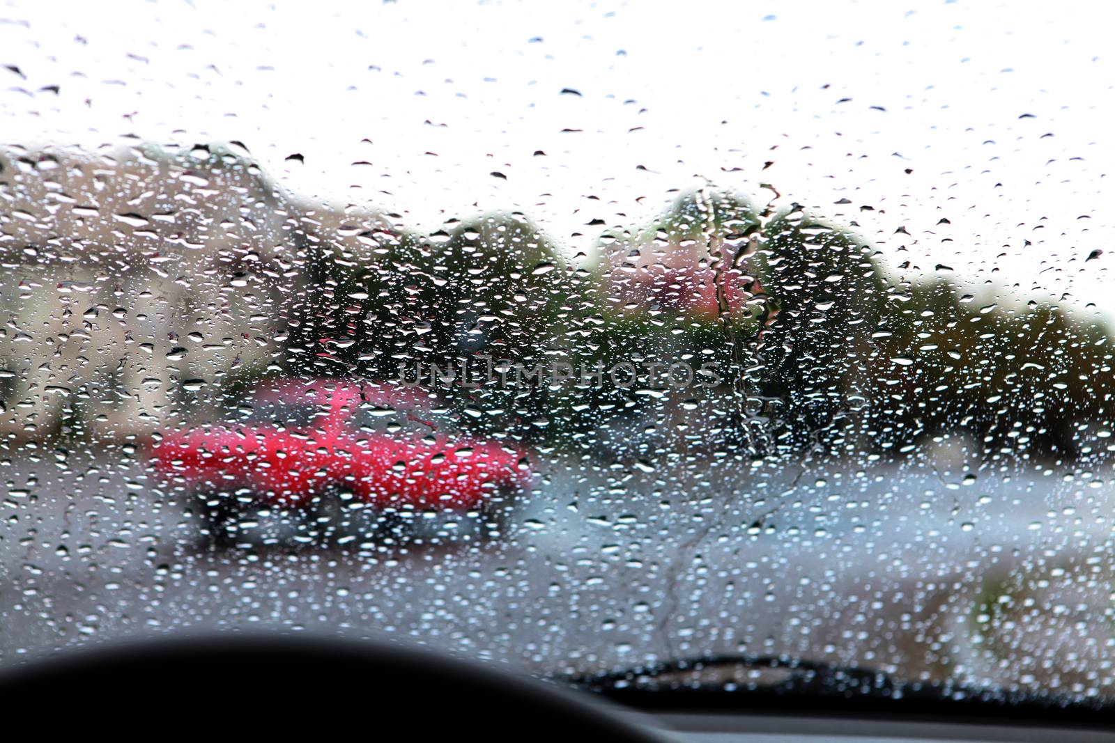 dashboard and rain droplets on car windshield