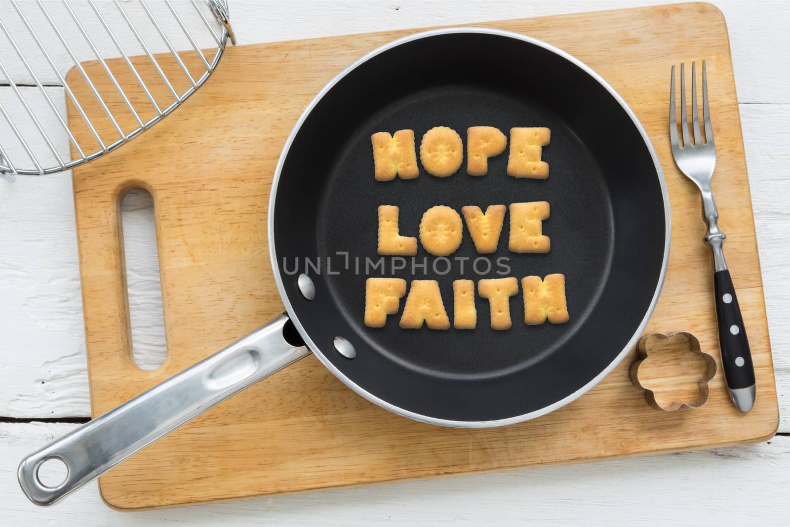 Letter biscuits word HOPE LOVE FAITH and cooking equipments. by vinnstock